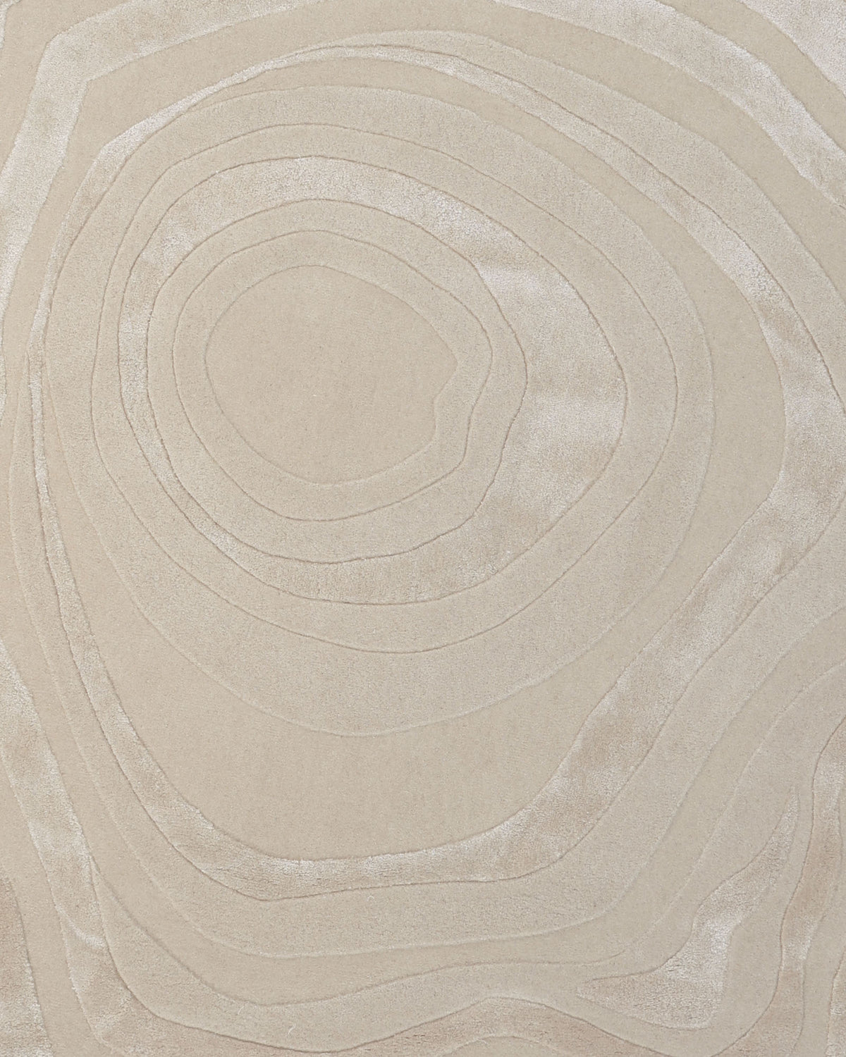 Introducing the Handmade Beige Organic Shape Rug with Wave Pattern 200x300 cm – HTWV 210 by RAMSHA HOME. Featuring a beige surface adorned with concentric, irregular oval lines reminiscent of topographic map contours, this rug creates a subtle textured pattern ideal for modern interiors. Its neutral tones offer understated sophistication and contemporary charm, making it an elegant addition to any space.