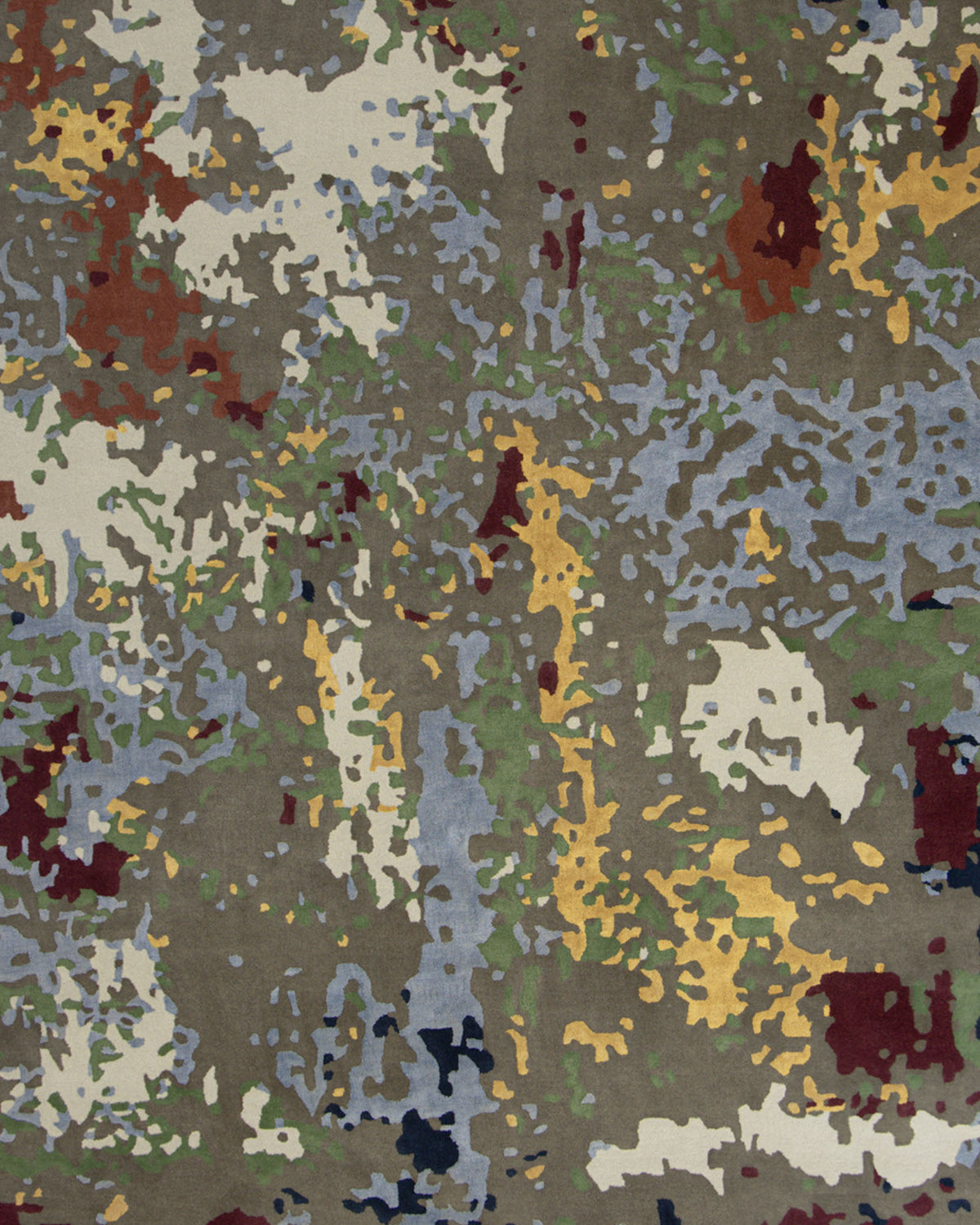 A detailed close-up of the RAMSHA HOME Modern Artistic Handmade Rug 240x300 cm- ZUA-21 reveals an abstract camouflage-inspired pattern with irregular blotches of green, brown, blue, yellow, white, and maroon—creating a striking contemporary look that brings modern style to any space.