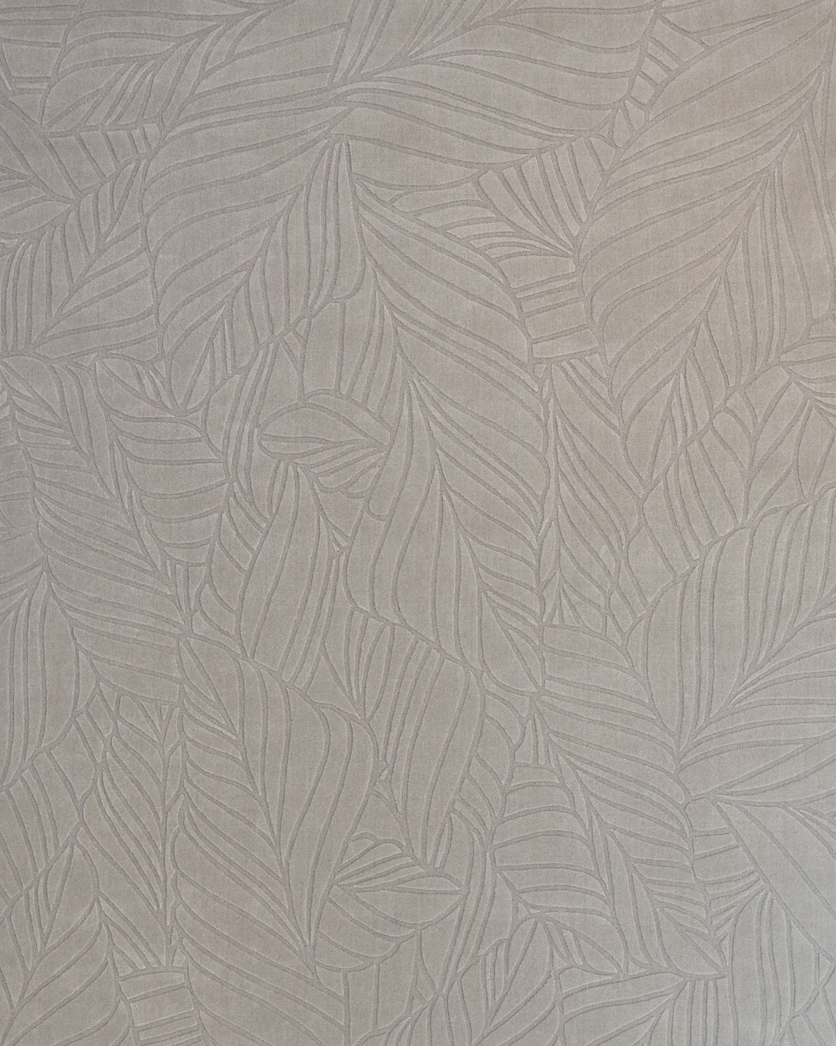 Introducing the Rectangle Handmade Decorative Grey Color Area Rug - LKH-030 from RAMSHA HOME: This rug features a light gray textured surface with an embossed pattern of overlapping, stylized leaves. Its subtle, monochromatic leaf design evokes the refined craftsmanship of a loom-knotted rug, creating a calm and sophisticated botanical ambiance akin to an elegant neutral area rug.
