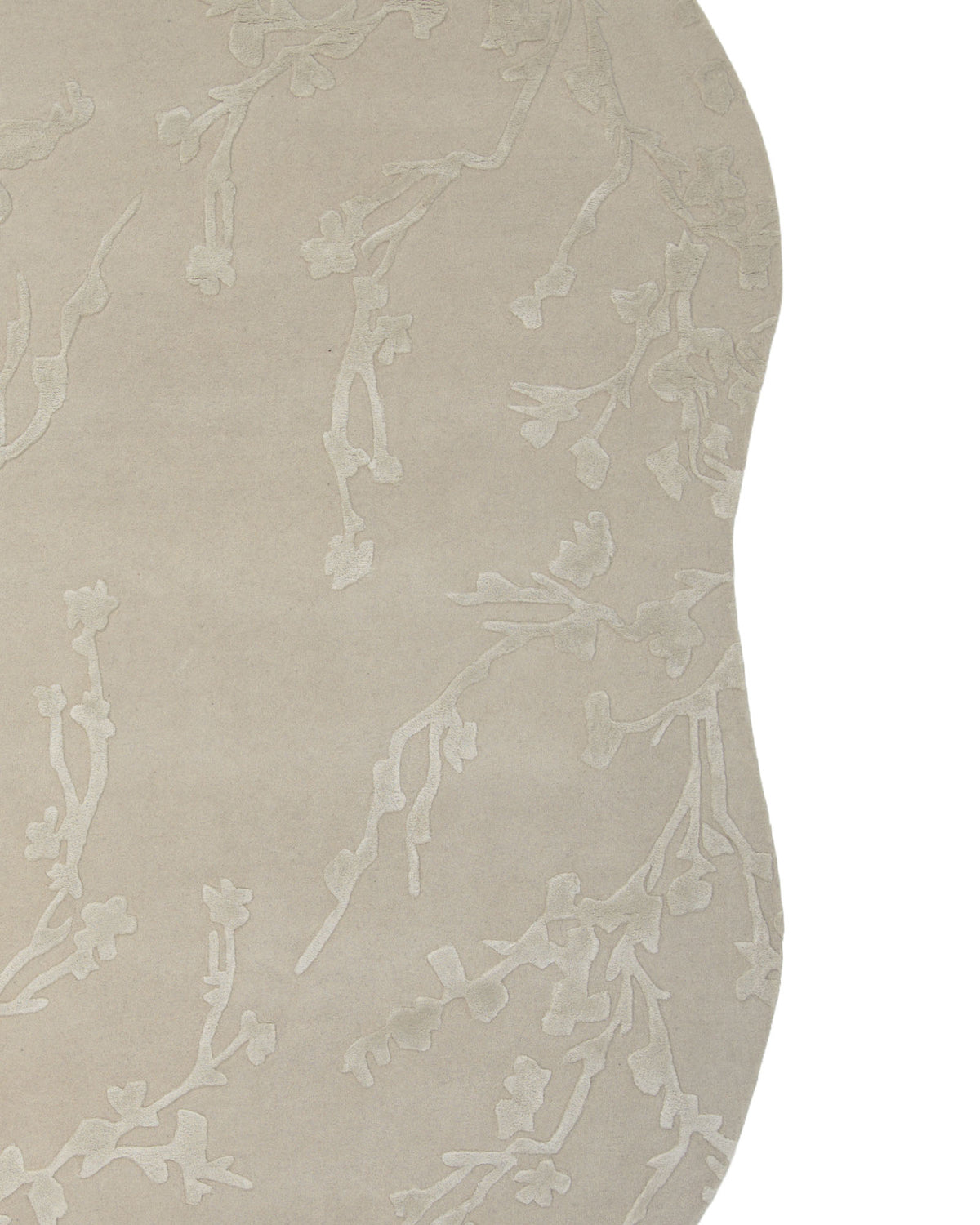 The RAMSHA HOME Decorative Handmade Area Rug HTWV-118 features a beige, irregular shape and is hand tufted from a wool blend, showcasing a subtle raised floral branch pattern on a smooth background.