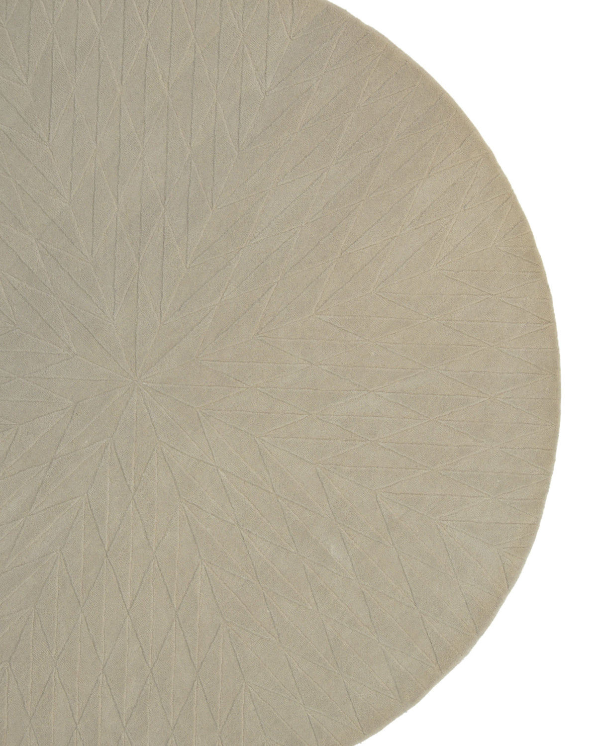 A close-up of the RAMSHA HOME Beige Handmade Round Rug HTW 107 (200cm) showcases its artisanal craftsmanship, with a subtle geometric starburst pattern embossed into the surface. The image captures only part of this natural fiber rug against a white background, highlighting its round shape and elegant beige tones.