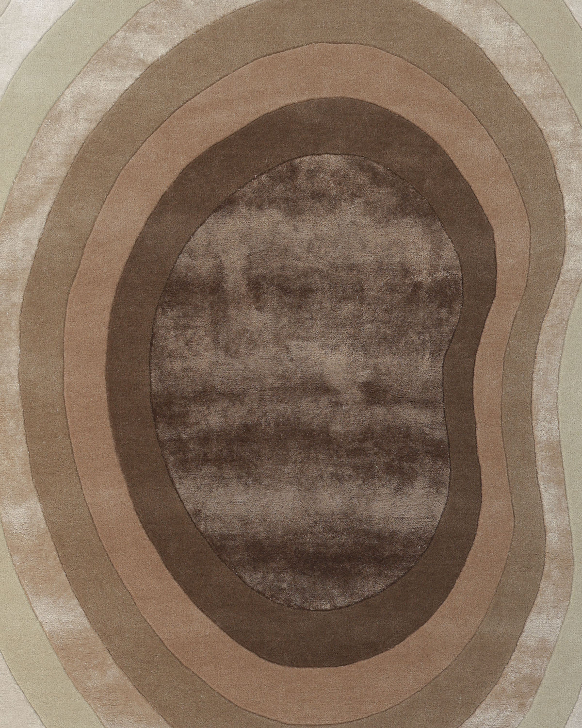 Introducing the RAMSHA HOME Vibrant Living Room Handmade Rug - HTWV-81 B (200x300cm): This oval-shaped brown abstract rug features concentric bands in beige and tan tones reminiscent of tree rings or topographic lines, highlighted by a smooth centerpiece and a luxuriously soft texture. Expertly crafted as a hand-tufted wool rug, it infuses any space with natural warmth and modern artistry.