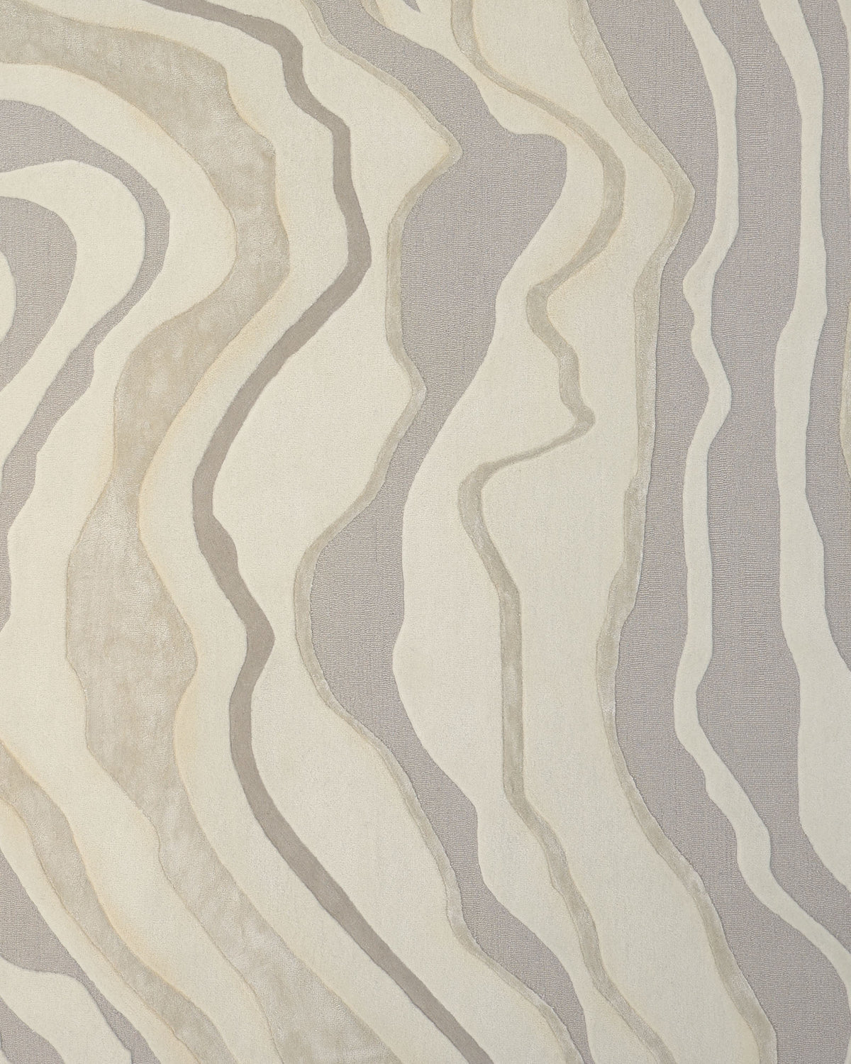 The Handcrafted Living Room Area Rug – HTWV-127 by RAMSHA HOME features an abstract design with wavy, organic lines in shades of beige, cream, and light gray, reminiscent of topographical or geological contour patterns. This modern rug offers a textured, layered effect, making it an elegant neutral area rug ideal for contemporary spaces.