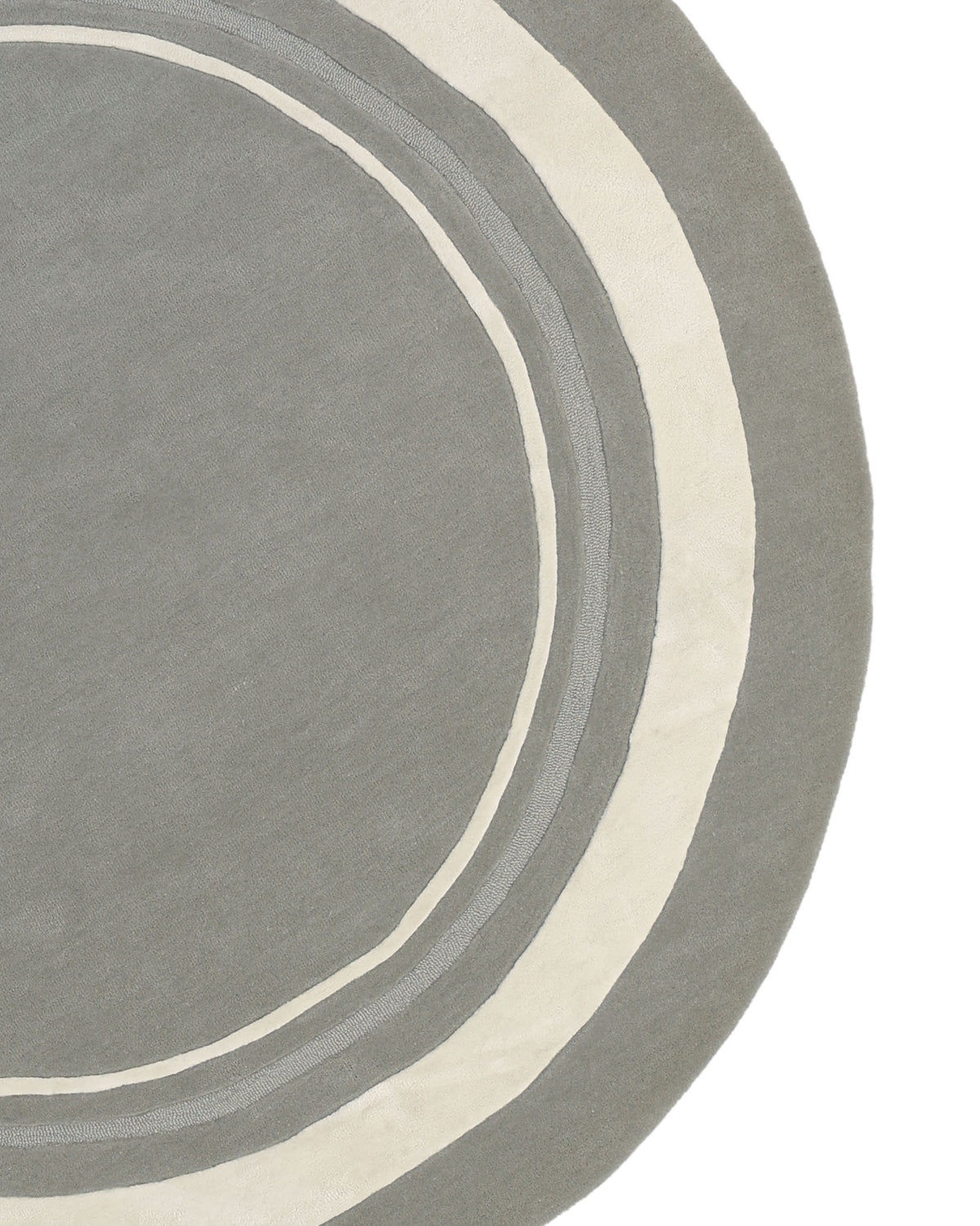 A section of the RAMSHA HOME “Grey & White Color Round Handmade Rug - HTWV-121,” a handtufted wool piece showcasing a round gray design with concentric cream and light gray rings near the edge, set against a white background.