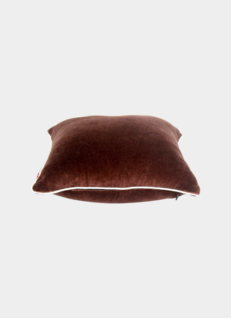 The RAMSHA HOME Polyester Cushion Plain With Filler cs-233 is a square, brown pillow with white piping, offering plush comfort and elegant decor, displayed on a plain light gray background.