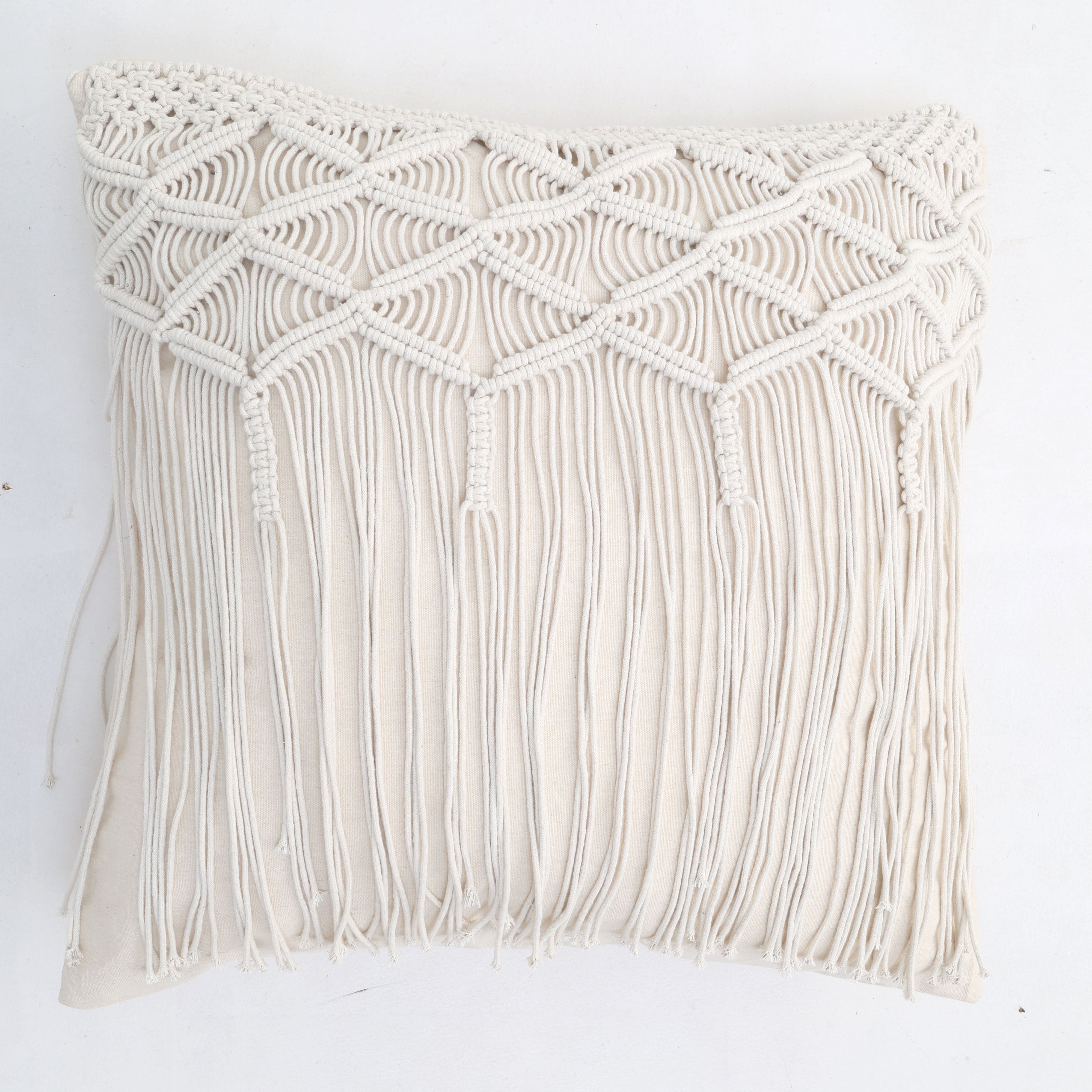 The Natural White Macrame Sofa Cushion - CS 309 by Ramsha Home features a handcrafted macramé cover with diamond patterns and long fringe, making it stand out against a white background.