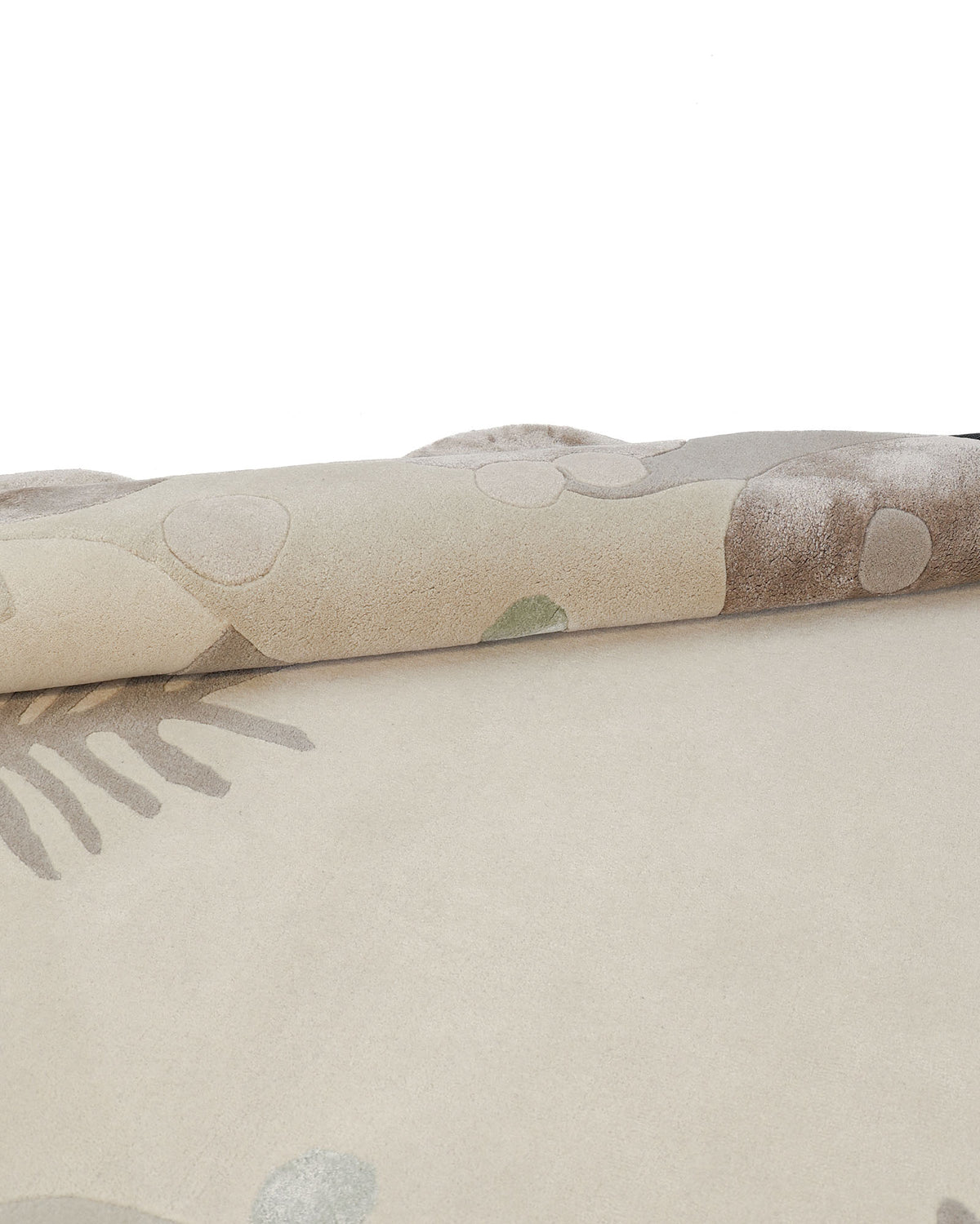 A close-up of the RAMSHA HOME Organic Shaped Rug with Abstract Floral & Botanical design (200x300 cm – HTWV 212) in beige, partially rolled up, showcasing light brown, green, and gray abstract patterns for a distinctive organic shape.