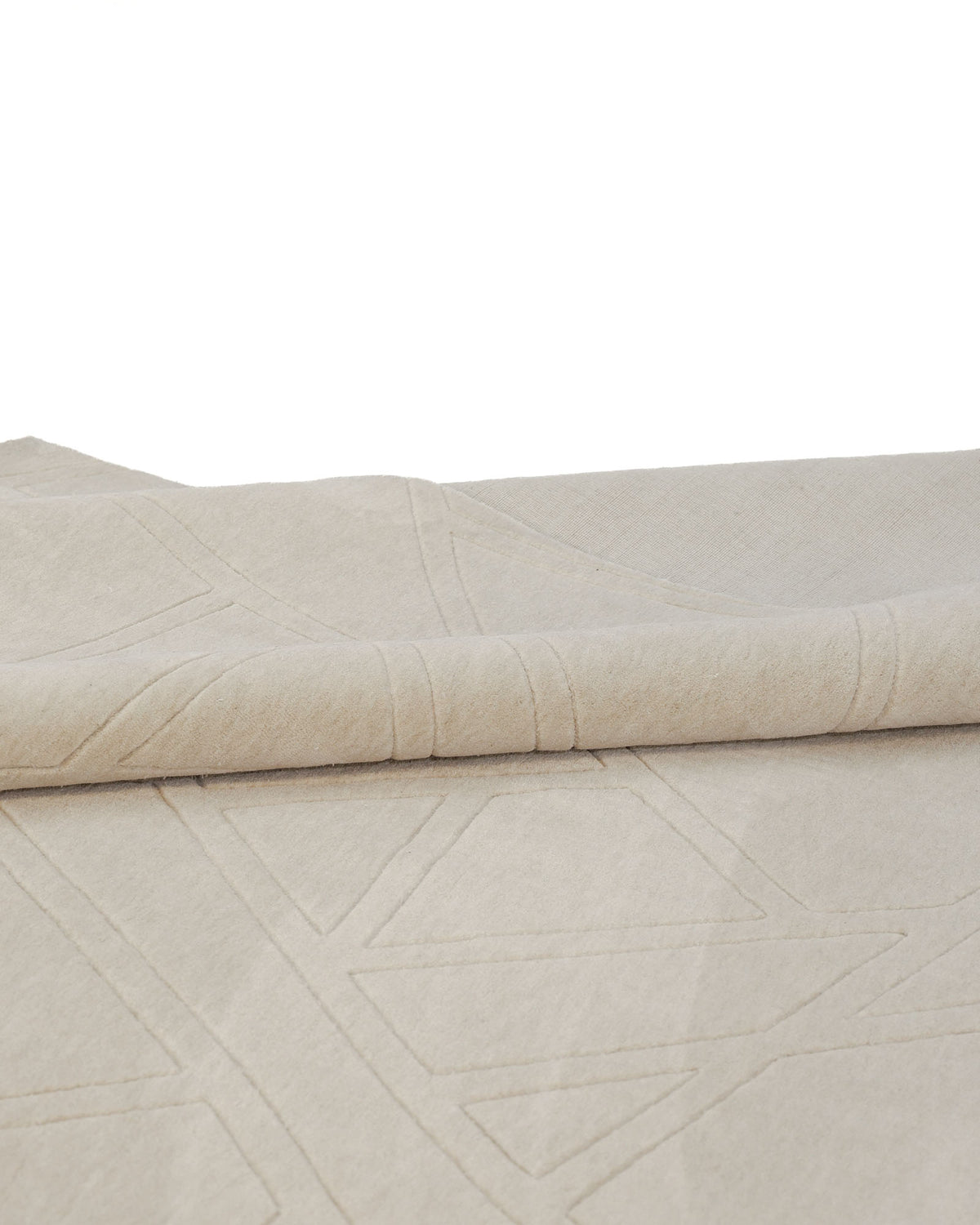 A close-up of the RAMSHA HOME Rectangle Home Decor Cream Color Handmade Area Rug (300x400 cm, LKH-045), showcasing its folded cream fabric with subtle geometric stitched patterns.