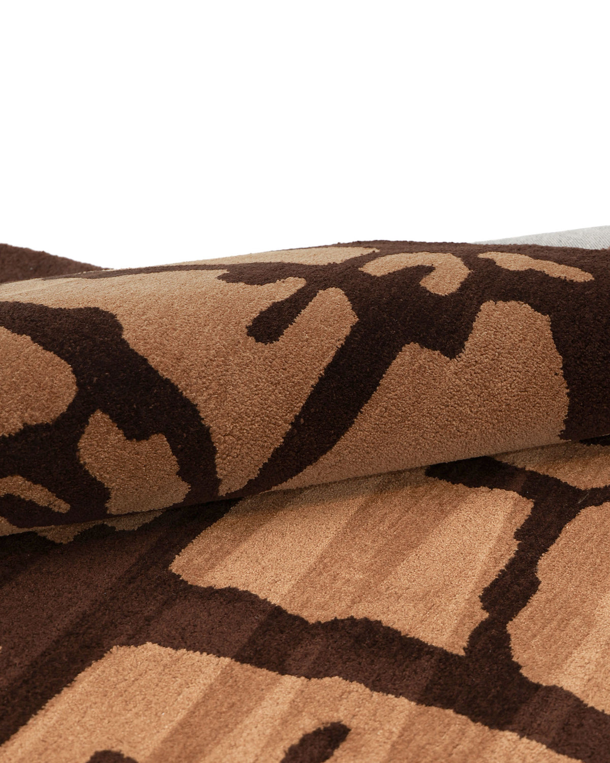 Close-up of the RAMSHA HOME Multi Handmade Area Rug - HTP 21 (200x300cm), featuring abstract, irregular shapes in shades of brown and tan on soft, textured fabric that highlights the modern design of this hand-tufted piece.