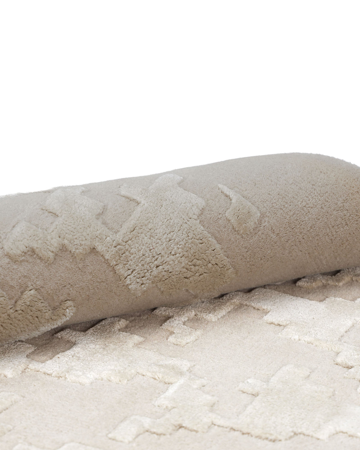 A close-up of the RAMSHA HOME Handmade Rectangle Living Room Rug HTWV-131 shows its beige, textured surface partially rolled up to highlight the raised and flat geometric patterns, adding subtle dimension to any space.