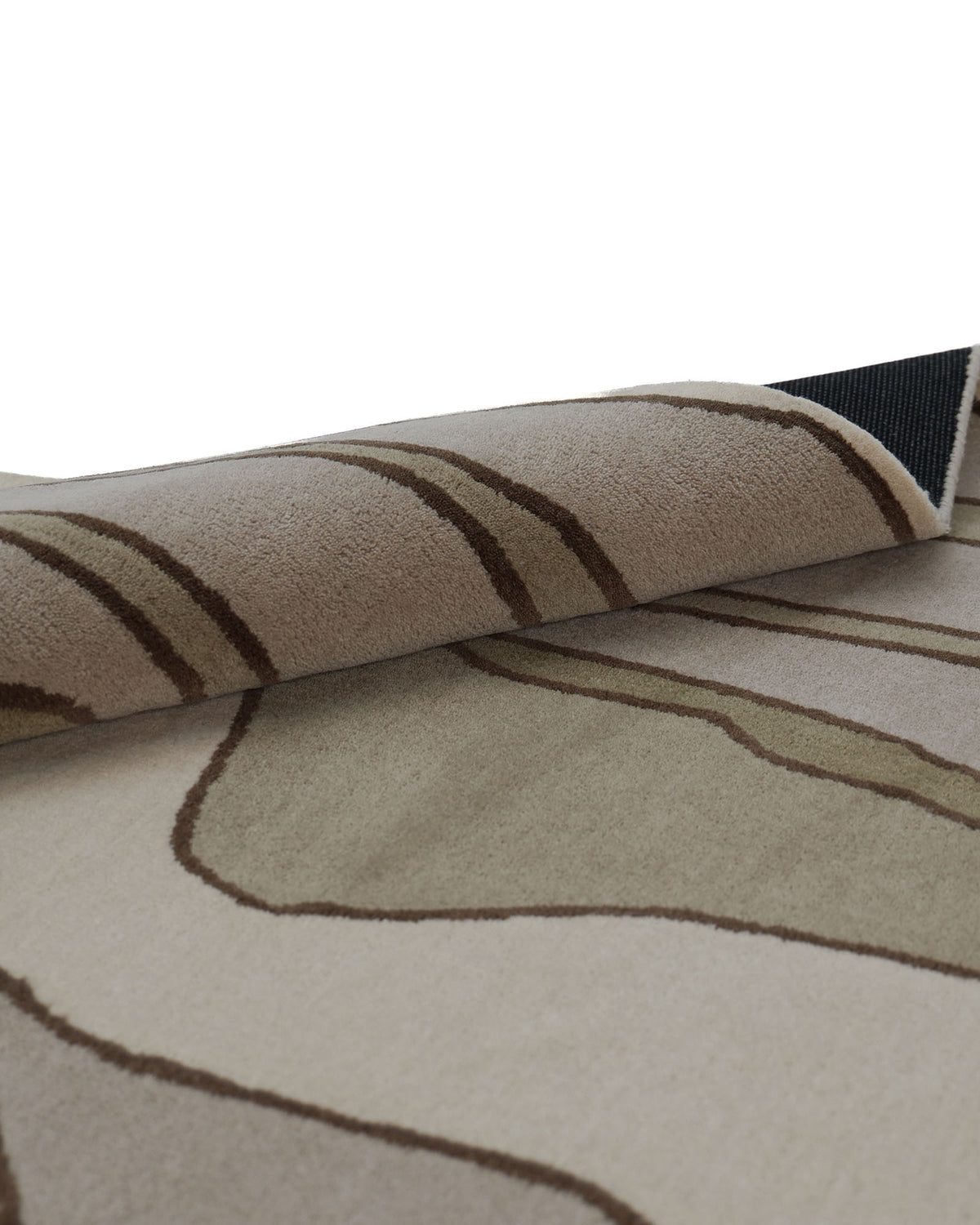 A close-up of the RAMSHA HOME Beautiful Home Decor Handmade Carpet – HTW-66, a beige and brown hand-tufted wool rug featuring abstract wavy lines, shown as a rectangular rug slightly rolled at one edge to highlight its texture and backing.