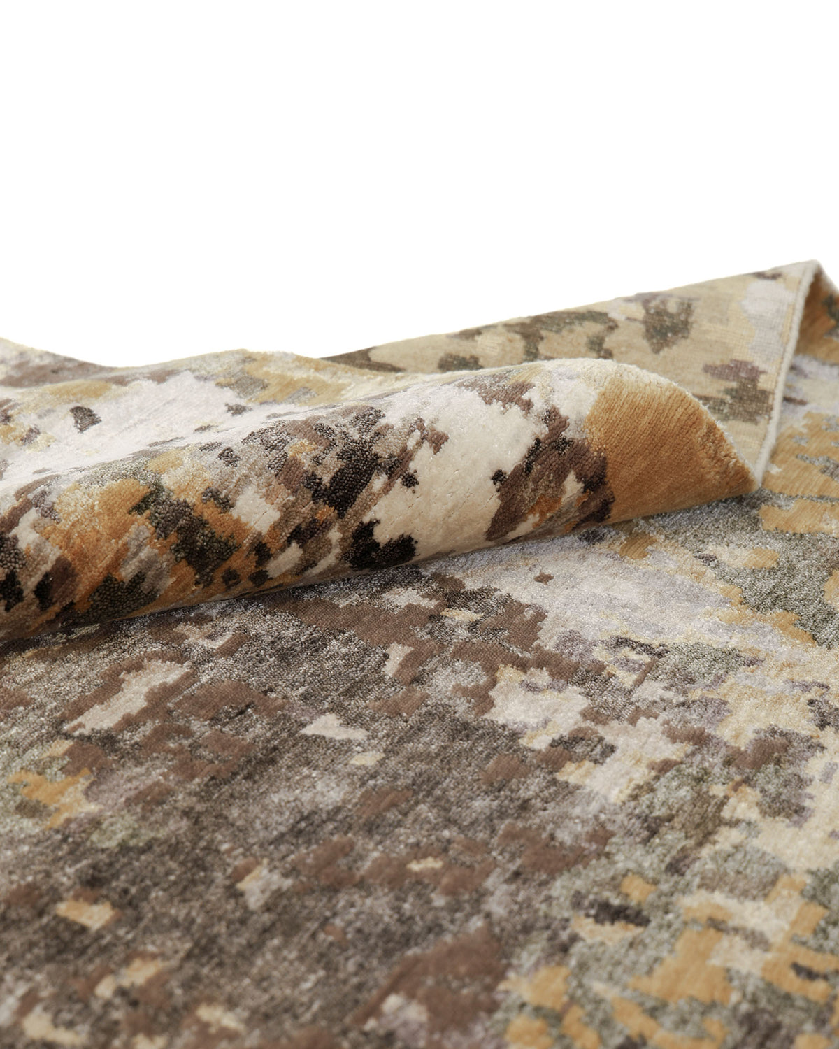 A close-up of the RAMSHA HOME Bamboo Silk & Cotton Carpet HKWB-014, hand-knotted and folded to display its textured abstract pattern in shades of brown, beige, gray, and cream. The slightly lifted edge highlights the thickness and intricate weave of the rug.
