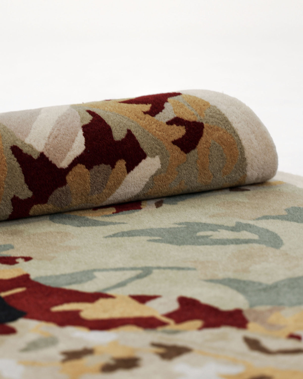 A close-up of the RAMSHA HOME Round Multi Area Rug 200 cm (HTW-73), a hand-tufted living room rug featuring beige, red, yellow, green, and brown floral patterns on a light background.