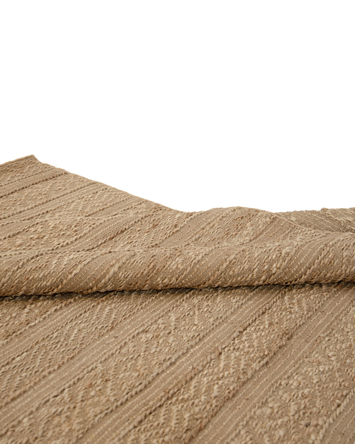 A close-up view of the Natural Color Hand Woven Area Rug WR-033 by RAMSHA HOME reveals its textured beige surface with a subtle striped pattern, gently folded at the center to showcase the rug’s thickness and intricate woven details—evoking the craftsmanship of natural jute fibers.