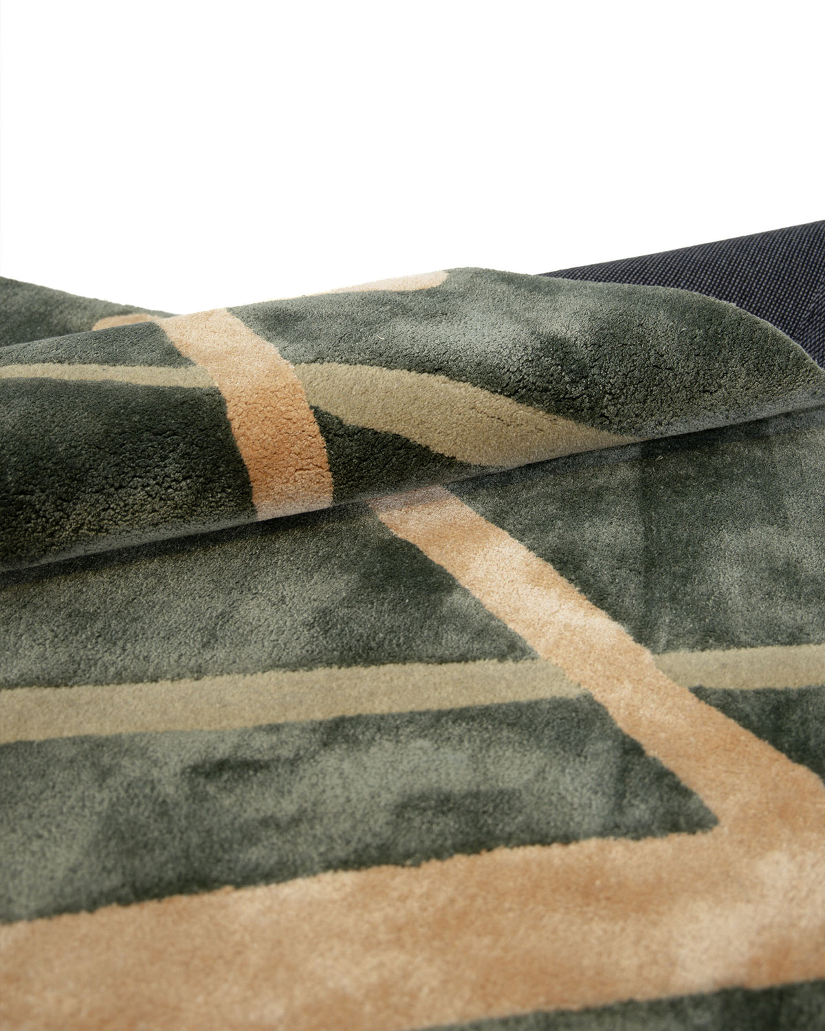 Close-up of the RAMSHA HOME Sage Green & Beige Contemporary Designer Rug (180x270 cm - HTWV 22), showcasing its plush, soft texture and modern abstract geometric pattern in soothing sage green tones, with a slightly folded corner for added dimension.