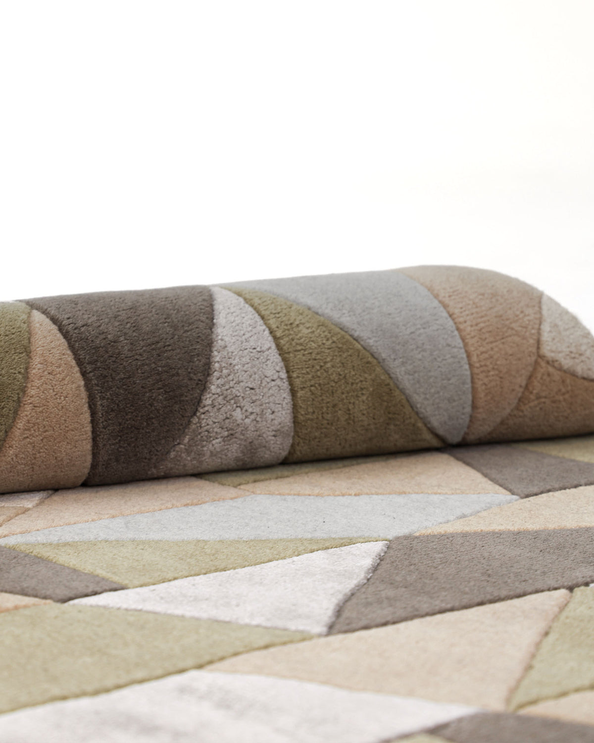 A close-up of the RAMSHA HOME Handmade Round Carpet For Home Decor 200 CM HTWV-47, showcasing hand-tufted geometric patterns in muted shades of green, beige, brown, and gray on a light background.