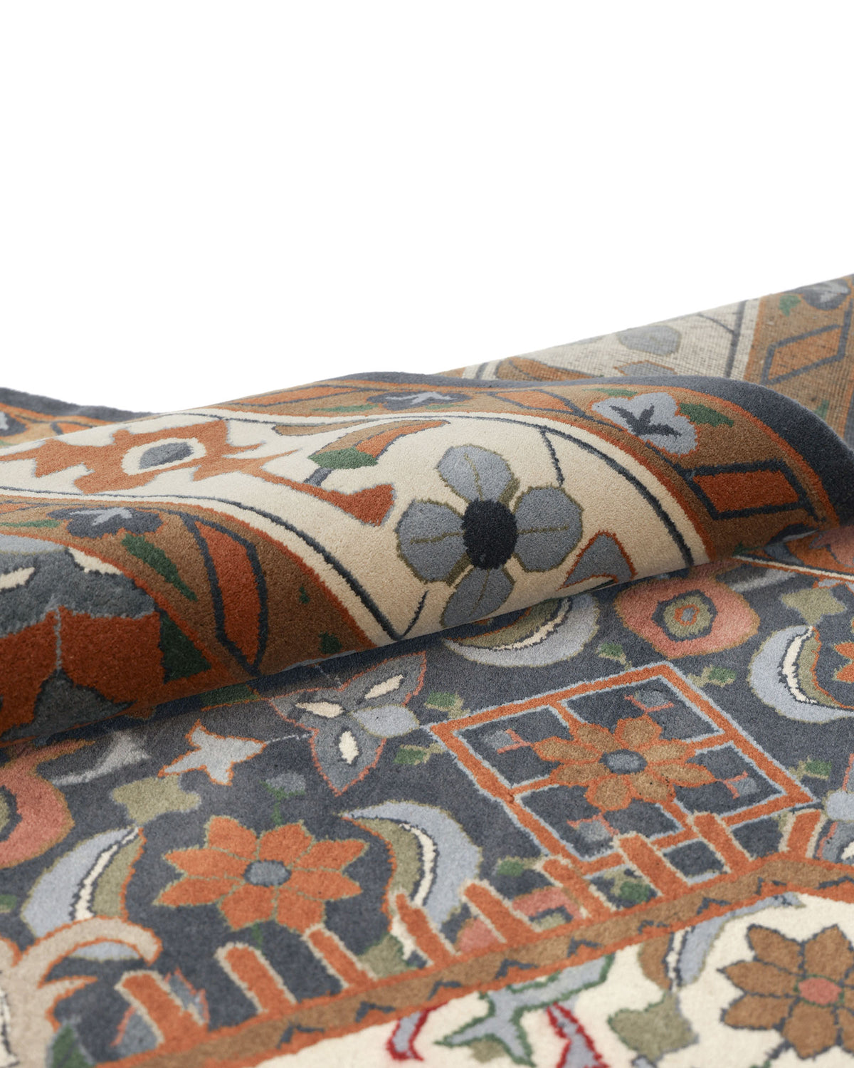A close-up of the RAMSHA HOME Hand Knotted Traditional Persian-Inspired Floral Medallion Rug (240x375 cm, HKW-07), showcasing its folded surface with visible texture and intricate floral and geometric detailing in blue, orange, green, and cream tones.