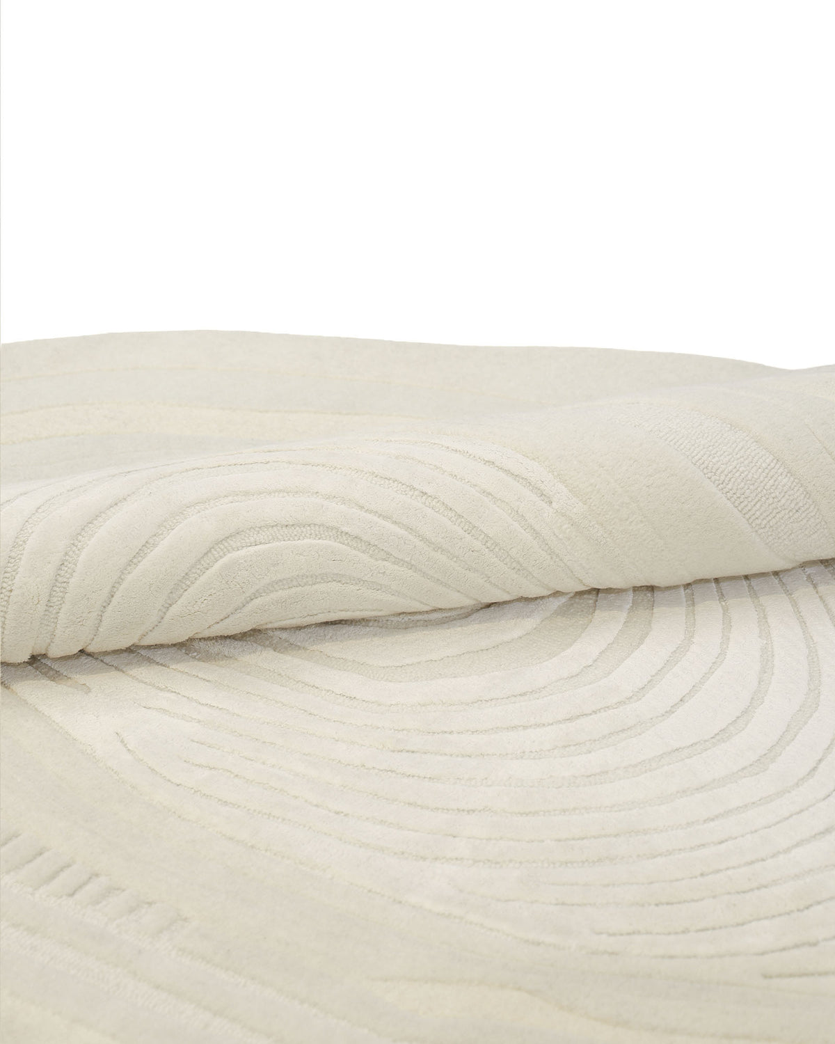 A close-up of the RAMSHA HOME Ivory Topographic Shaped Rug 200x300 cm (Rug HTWV-192) reveals its elegant, cream-colored surface adorned with a subtle, raised geometric swirl pattern, making it a refined statement piece for any space.