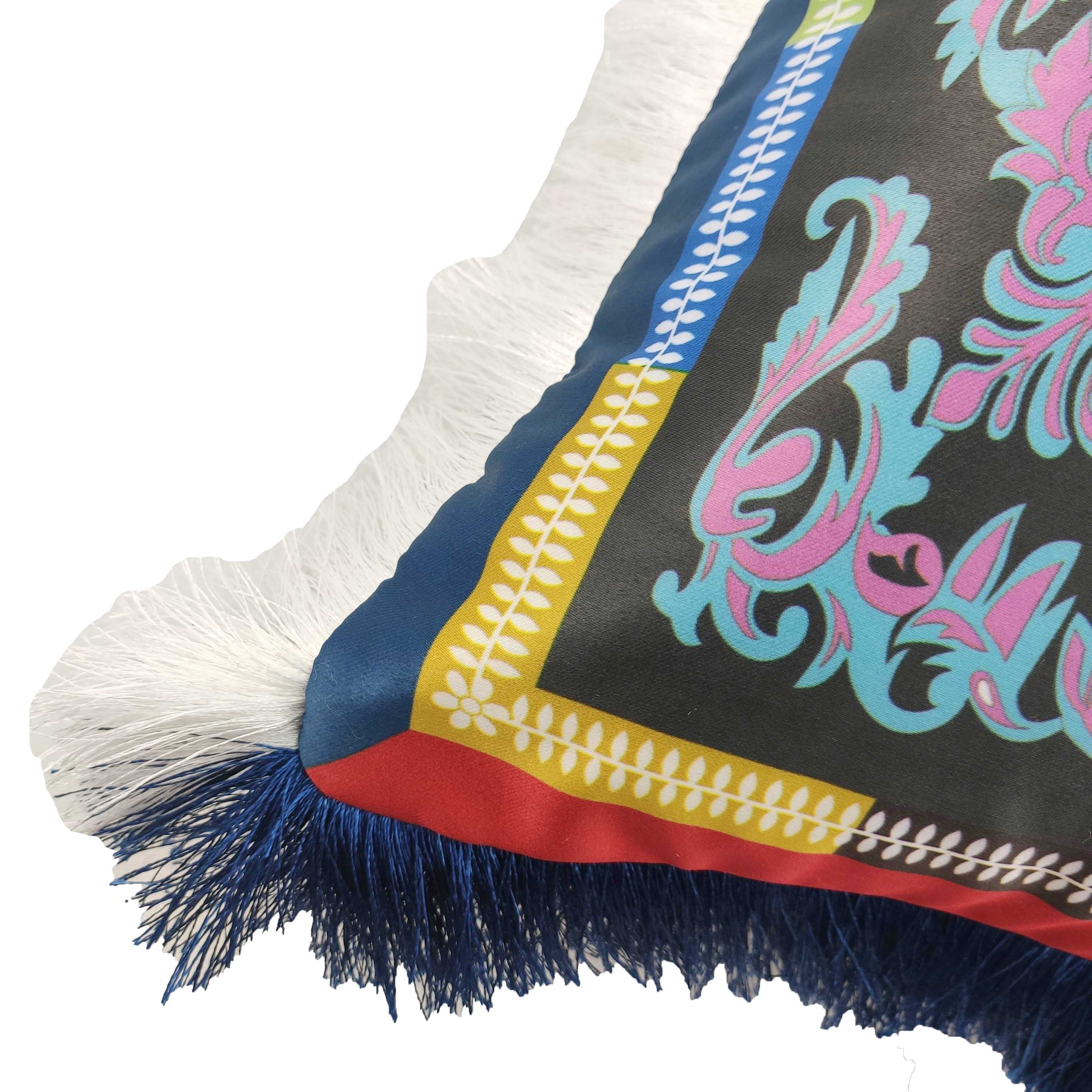 The RAMSHA HOME Polyester Cushion Multi Color CS-058 features an ornate floral pattern with a blue, yellow, and red border plus white and dark blue fringe along the edge for added style.