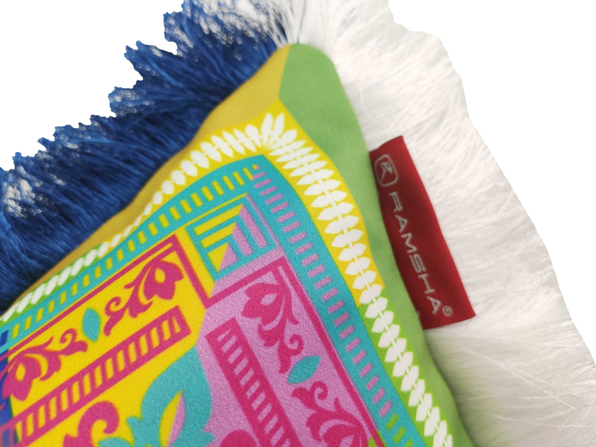 The Modern Printed Cushion With Filler CS-057 by RAMSHA HOME features blue and white fringes, vibrant yellow, green, pink, and blue patterns for a cozy look, plus a side red tag with the brand name attached.