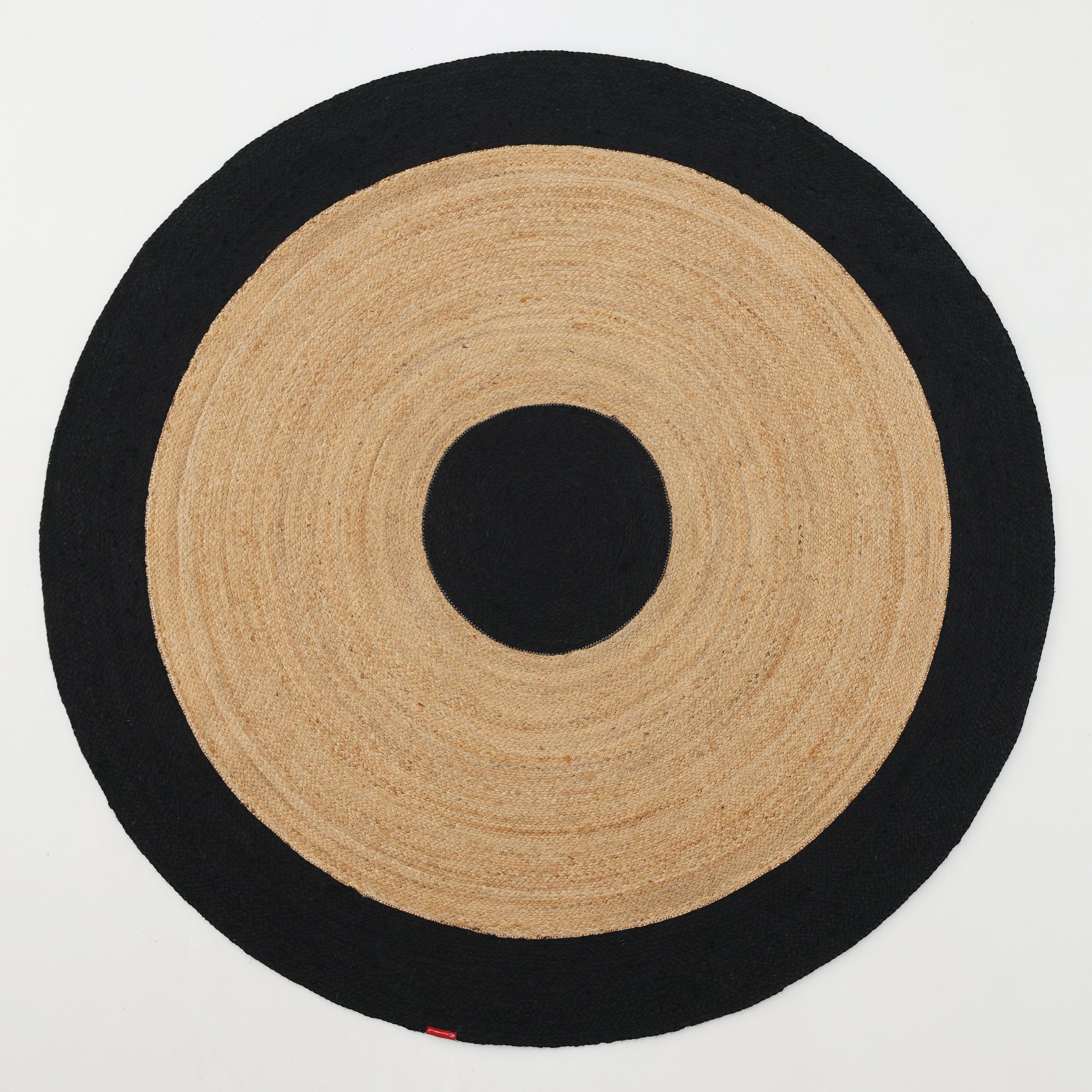 The RAMSHA HOME Braided Rug Jute carpet (BR-003) features concentric circles with a black center, tan ring, bold black border, and braided jute design—perfect for bedroom or living room décor.