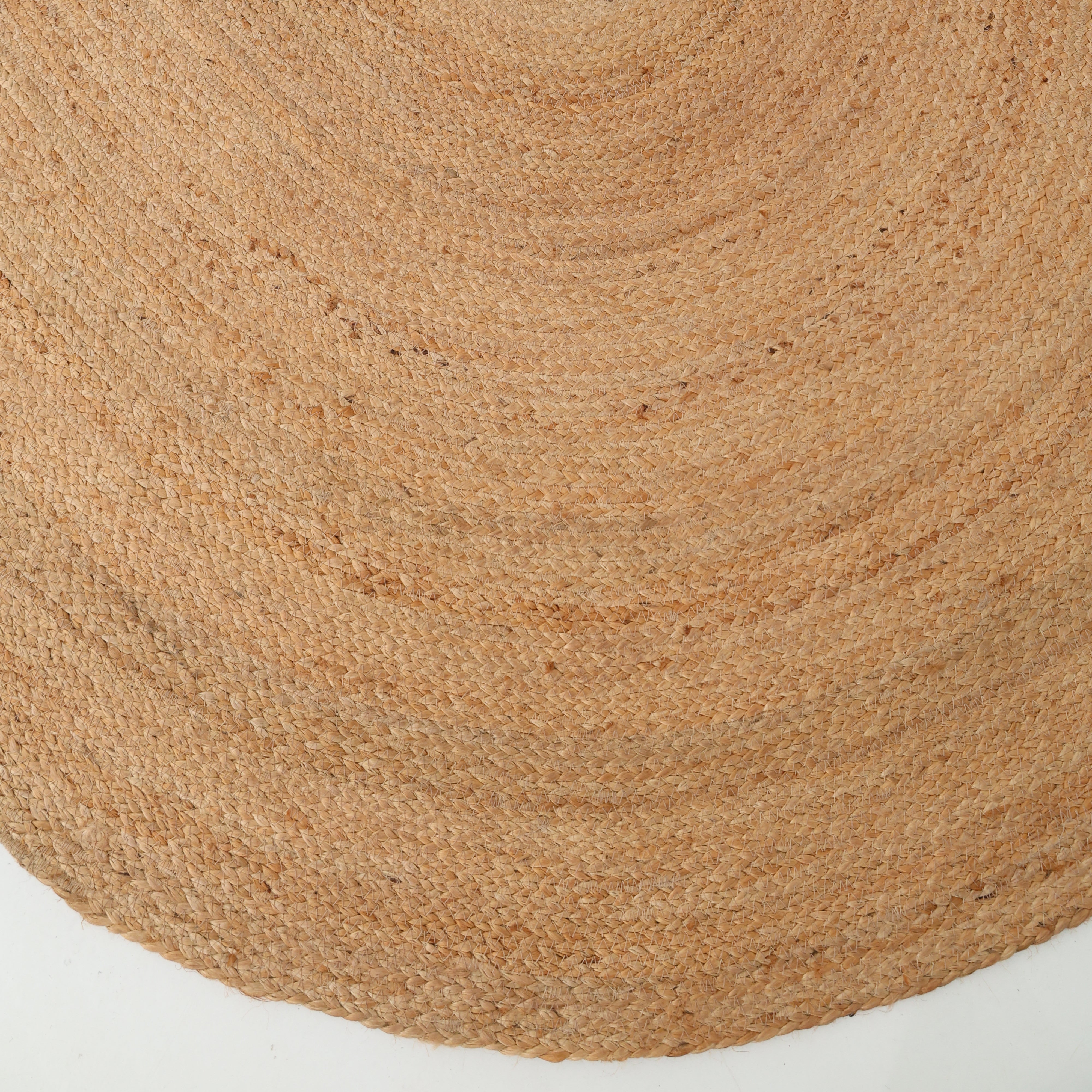 Close-up of the RAMSHA HOME Handmade Natural Color Oval Shape Braided Rug (BR 036) showcasing its textured, tan jute fibers against a white background, highlighting the timeless appeal of natural fiber rugs.