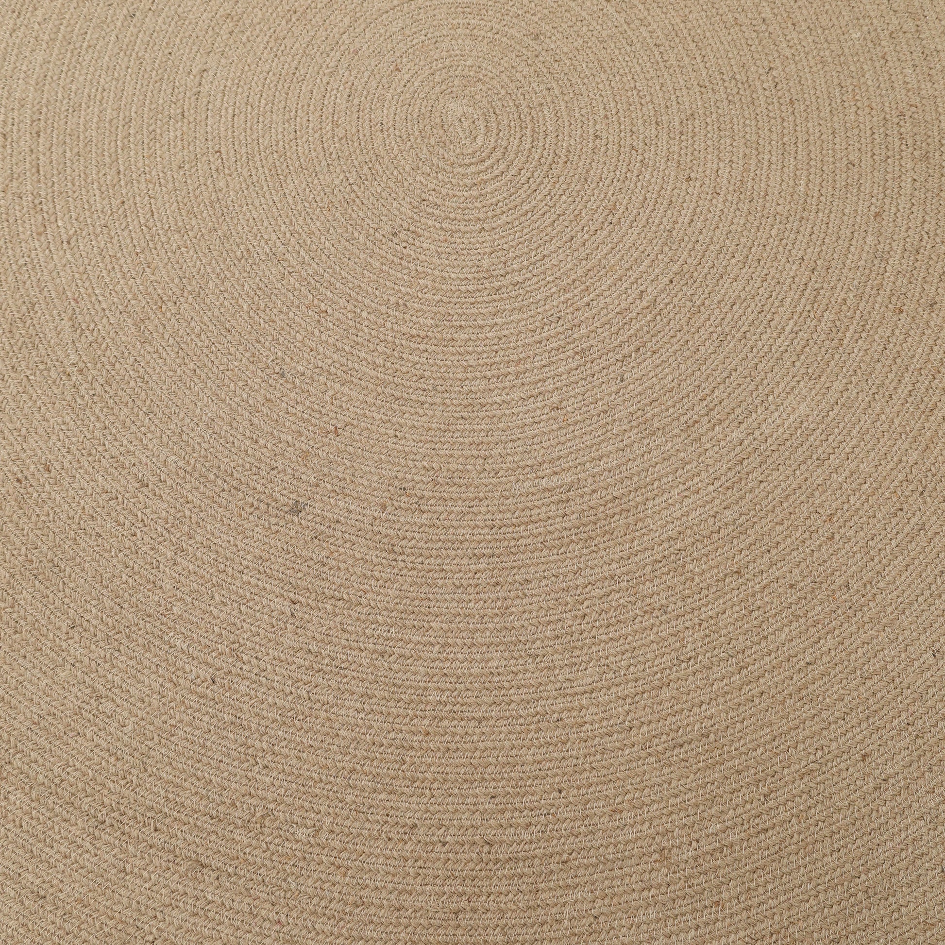 The RAMSHA HOME Stunning Handmade Jute Indoor & Outdoor Round Braided Rug - BR 014 features a beige design with concentric rings of textured jute fibers radiating from the center, perfect for adding natural warmth to any space.