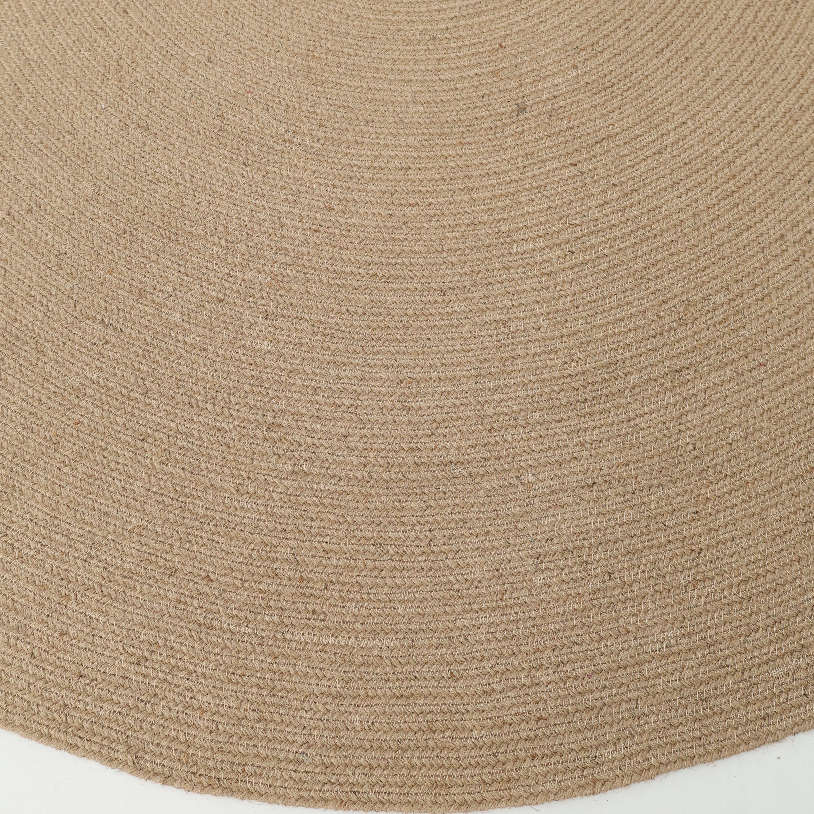 Close-up of the RAMSHA HOME Stunning Handmade Jute Indoor & Outdoor Round Braided Rug - BR 014, displaying its concentric circular patterns and tightly braided natural fibers against a white background.