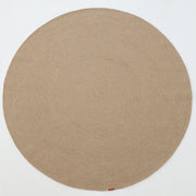 The RAMSHA HOME Stunning Handmade Jute Indoor & Outdoor Round Braided Rug - BR 014 in beige features a subtle circular pattern and a small red tag on its edge, displayed on a white background.
