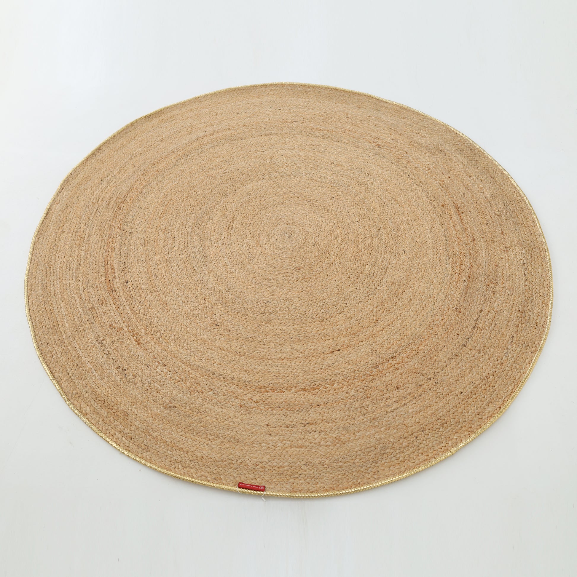 The Handmade Natural Color Braided Round Rug - BR 013 by RAMSHA HOME features a large, round design in natural beige tones and is displayed on a plain white background.