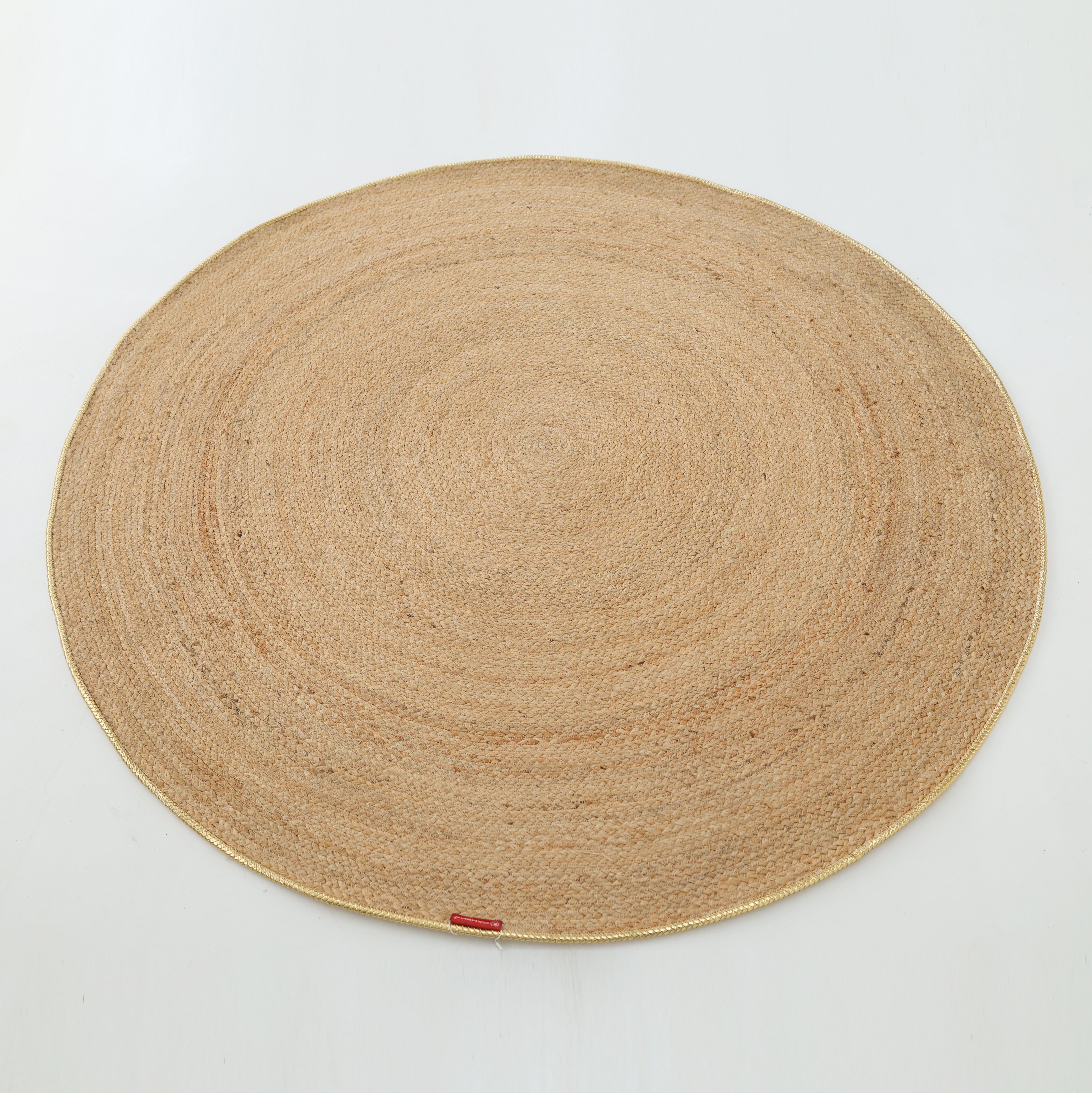 The Handmade Natural Color Braided Round Rug - BR 013 by RAMSHA HOME features a large, round design in natural beige tones and is displayed on a plain white background.