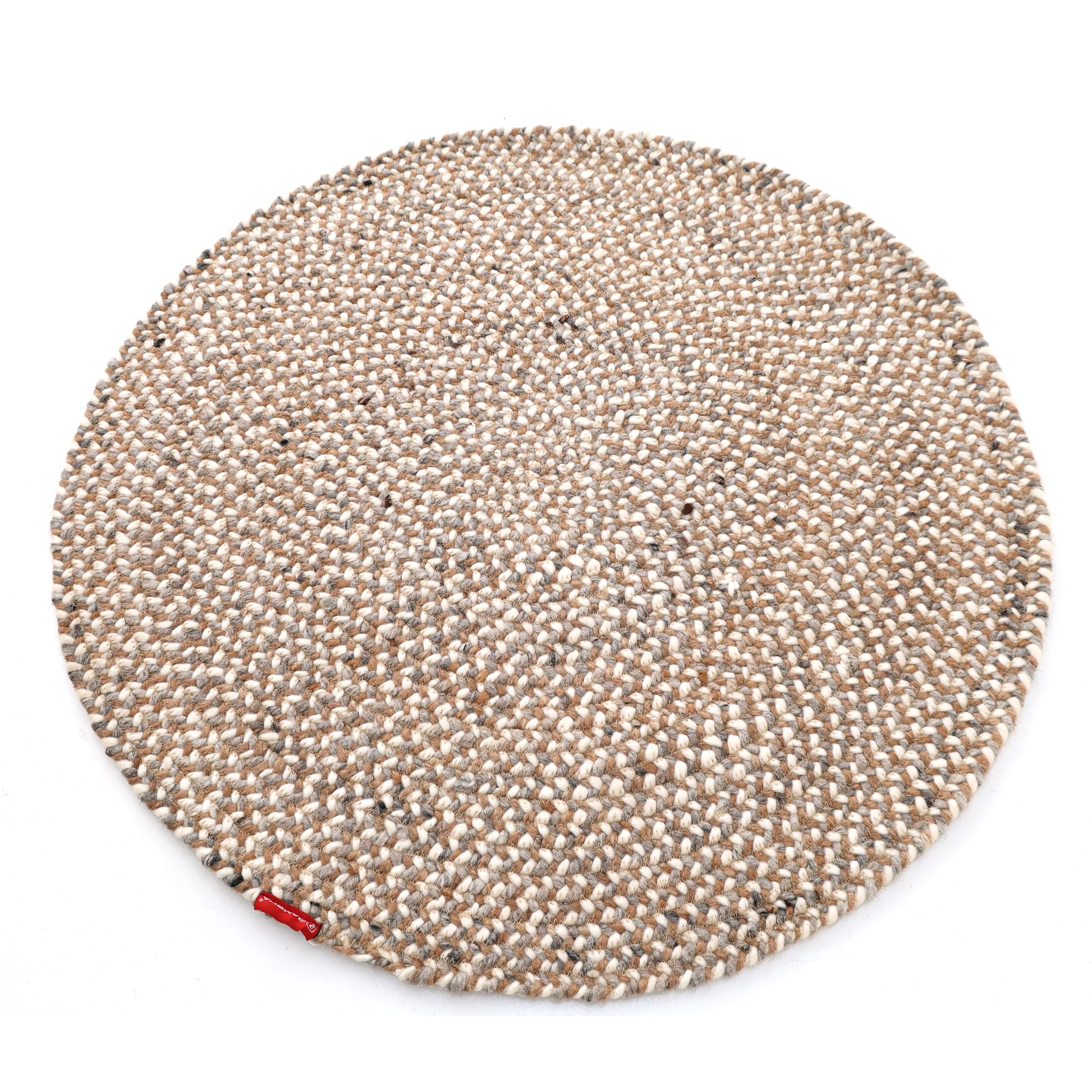 The RAMSHA HOME Natural Color Dining Room Jute Area Braided Rug - BR 096 is a modern, minimalist round beige rug with a textured woven surface and a small red tag on the edge, shown against a white background.