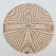 The Handmade Natural & White Color Braided Jute Round Rug - BR 012, featuring a spiral braided pattern in beige and white and a small red label near the edge, is displayed on a plain white background.