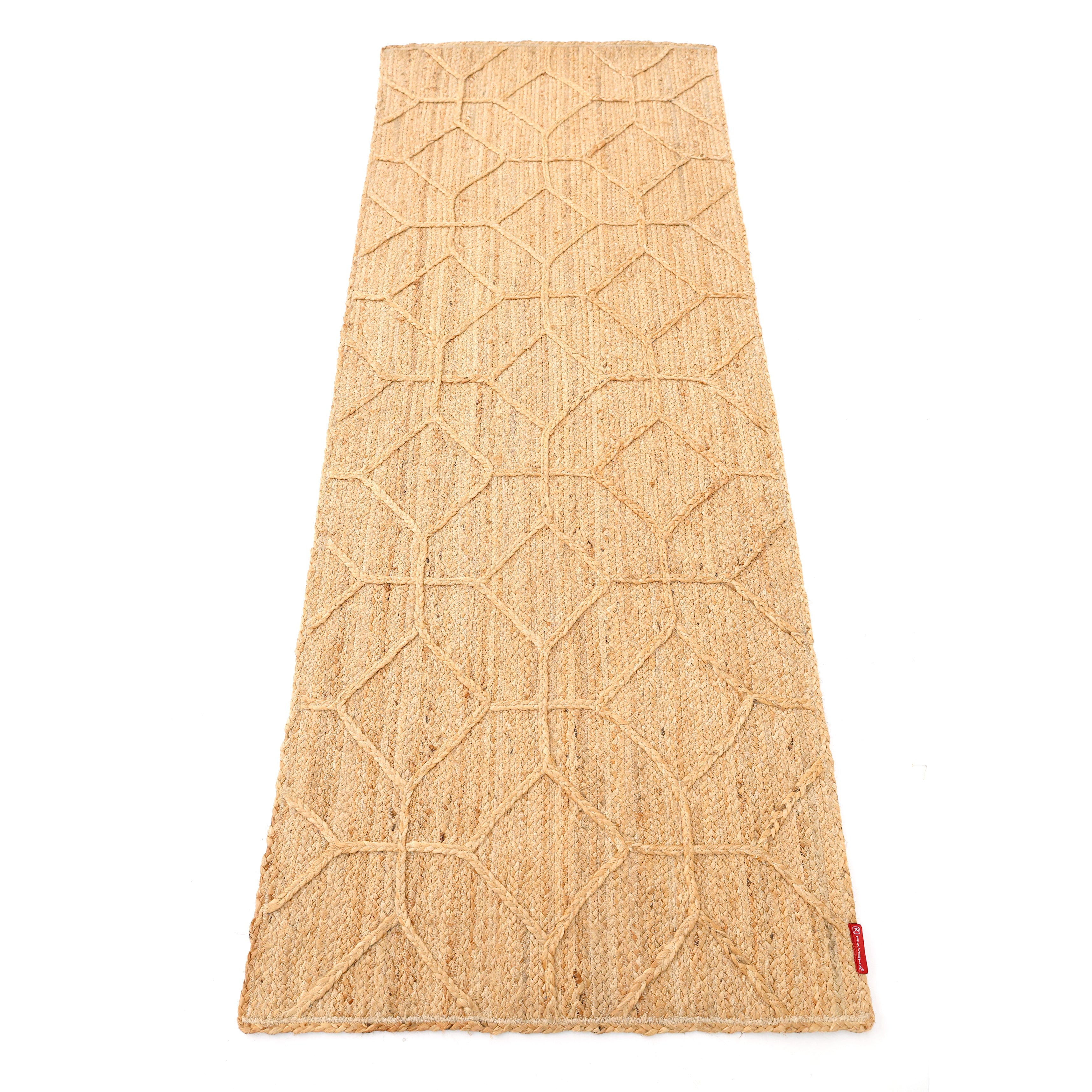 The RAMSHA HOME Natural Color Dining Room Jute Area Braided Rug - BR 076 is a rectangular, tan, textured rug with a geometric diamond pattern and a small red tag—ideal as a modern minimalist accent.