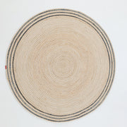 The RAMSHA HOME Creative Handcrafted Blue Border Braided Rug - BR 065 features concentric circular patterns and a blue decorative edge, adding texture and style to any space. Shown on a plain white background.