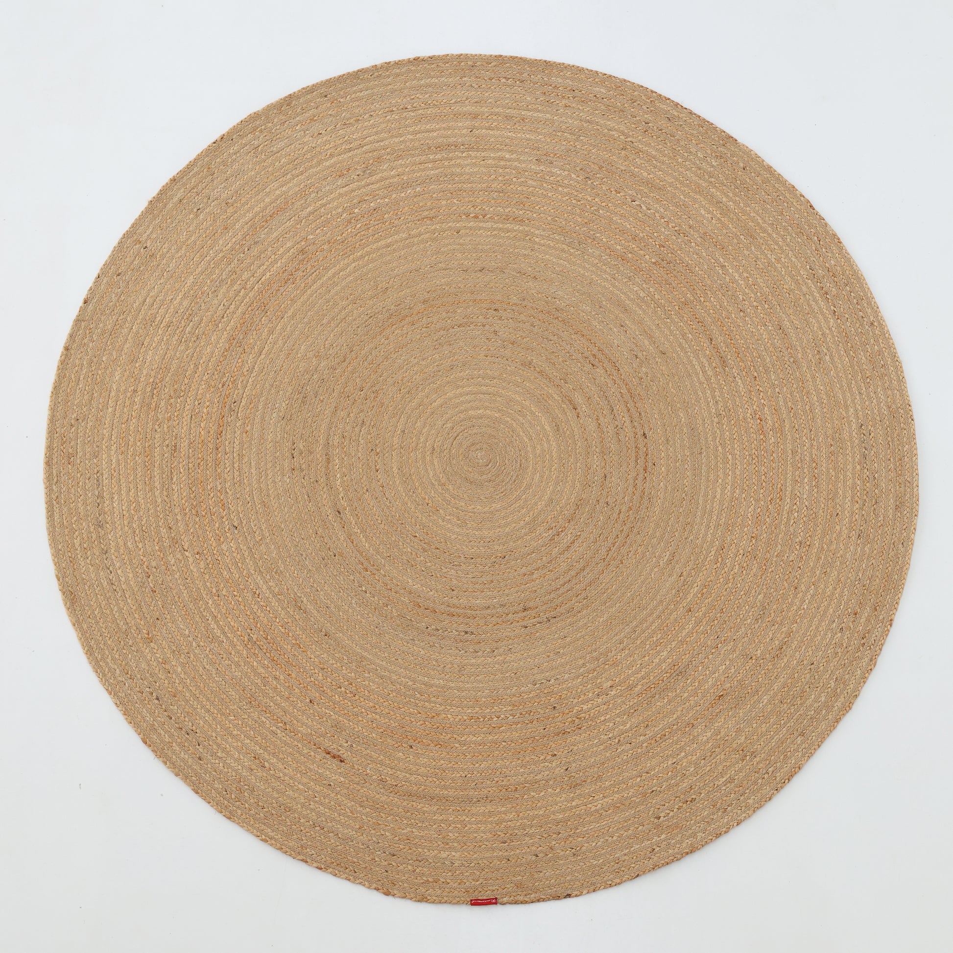 The RAMSHA HOME Luxurious Handmade Home Decor Jute Rug Circle - BR 088 is a light tan, round braided rug with spiral rings, displayed on a white background—perfect for adding natural warmth and texture to any room.