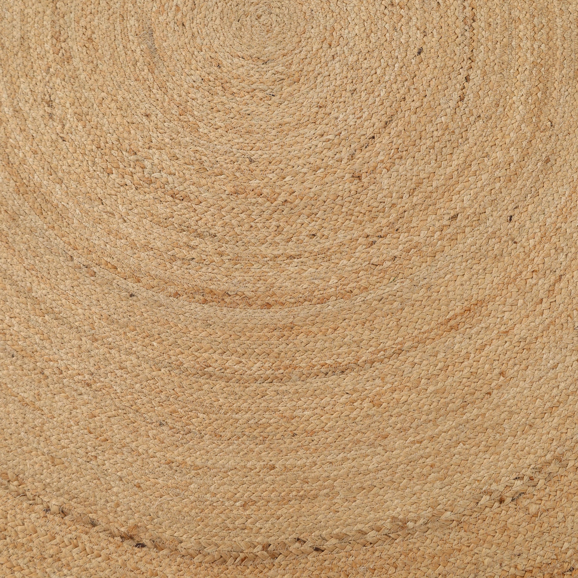 Close-up of the RAMSHA HOME Handmade Jute Braided Rug for Living Room BR-016, showing its woven circular design with concentric rings and textured light brown jute fibers.