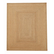 The Handmade Natural Color Drawing Room Jute Floor Braided Rug - BR 046 features concentric rectangles in tan and beige. Its textured, woven finish brings an earthy, rustic touch—ideal for cozy, relaxed spaces.