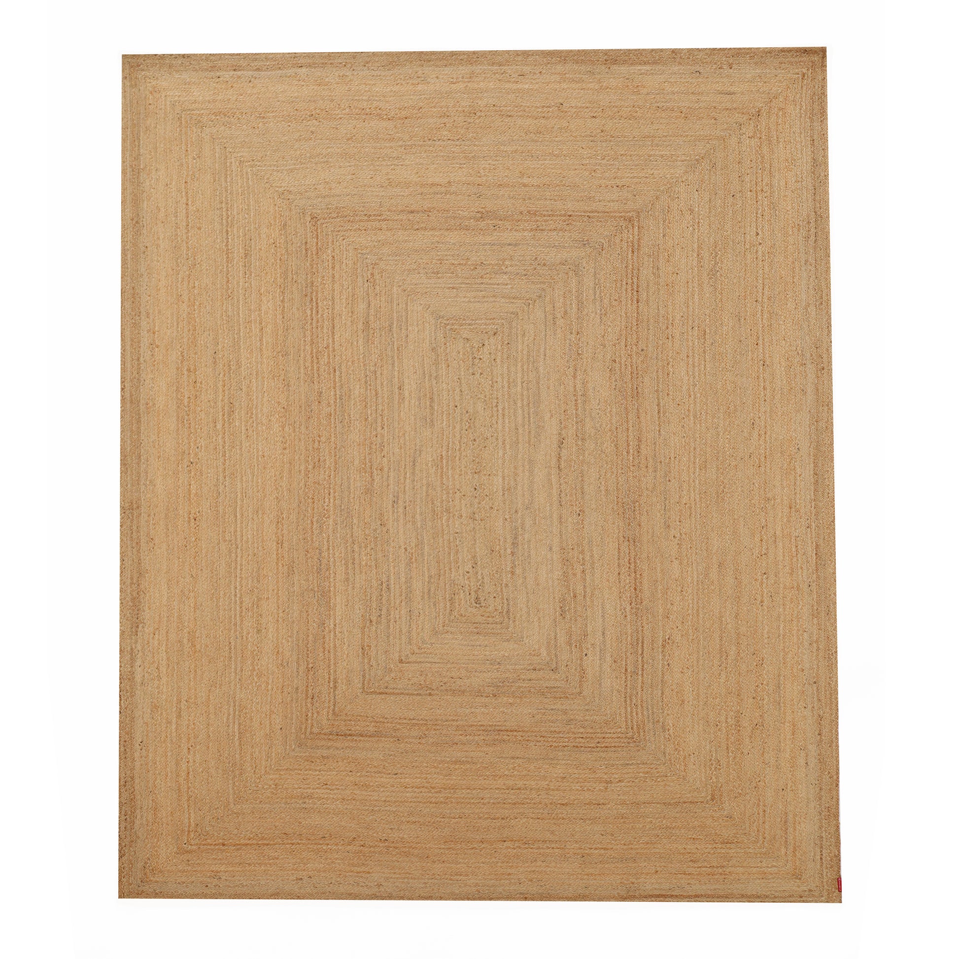 The Handmade Natural Color Drawing Room Jute Floor Braided Rug - BR 046 features concentric rectangles in tan and beige. Its textured, woven finish brings an earthy, rustic touch—ideal for cozy, relaxed spaces.