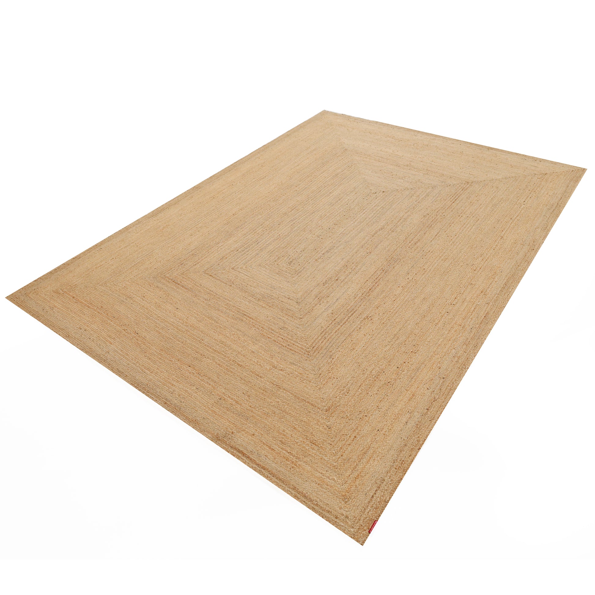 The Handmade Natural Color Drawing Room Jute Floor Braided Rug - BR 046 is a large, rectangular, light brown rug with a subtle pattern, crafted from natural jute and shown on a white background.