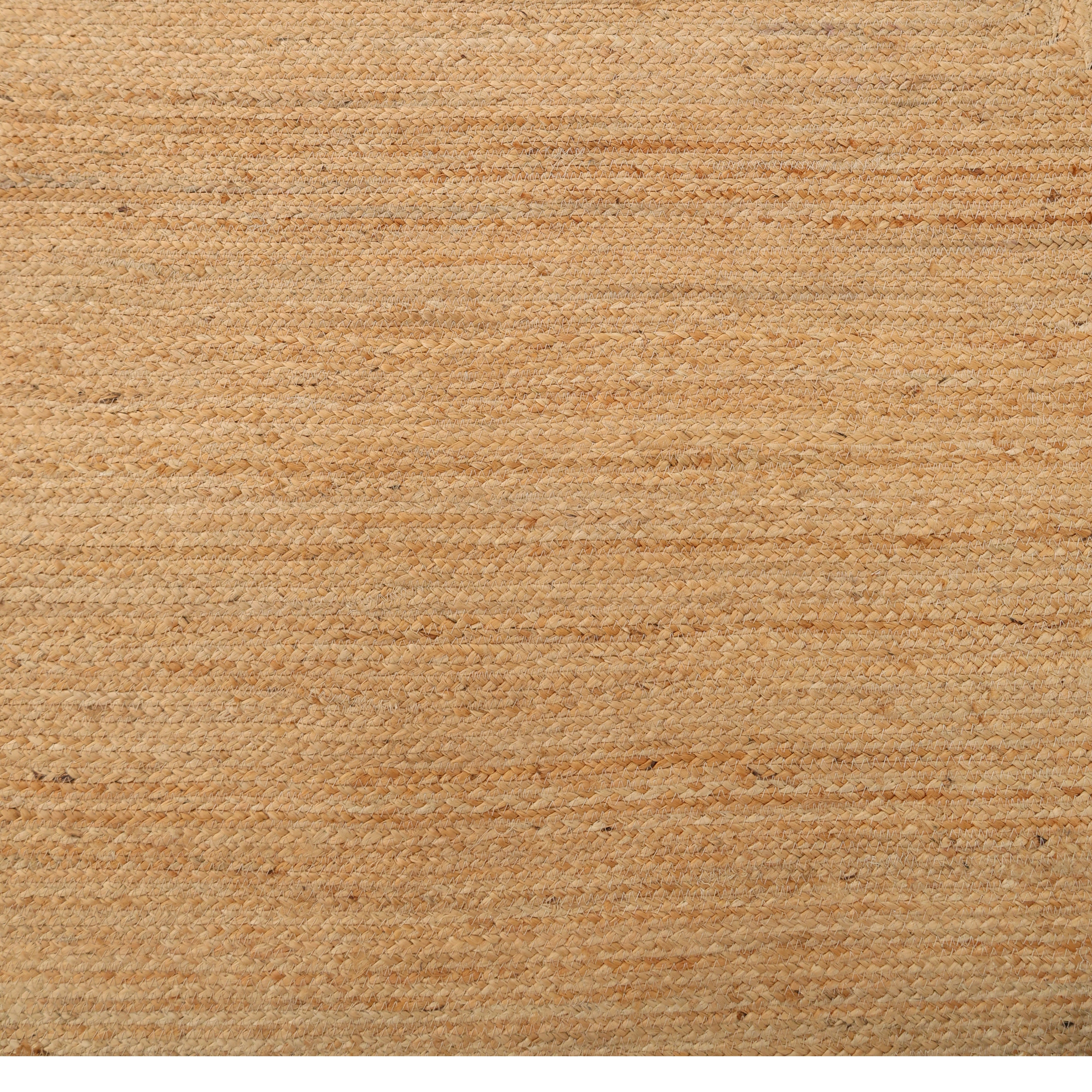 Close-up of the Handmade Natural Color Drawing Room Jute Floor Braided Rug - BR 046, showing its light brown tone, slightly rough texture, and subtle horizontal lines.