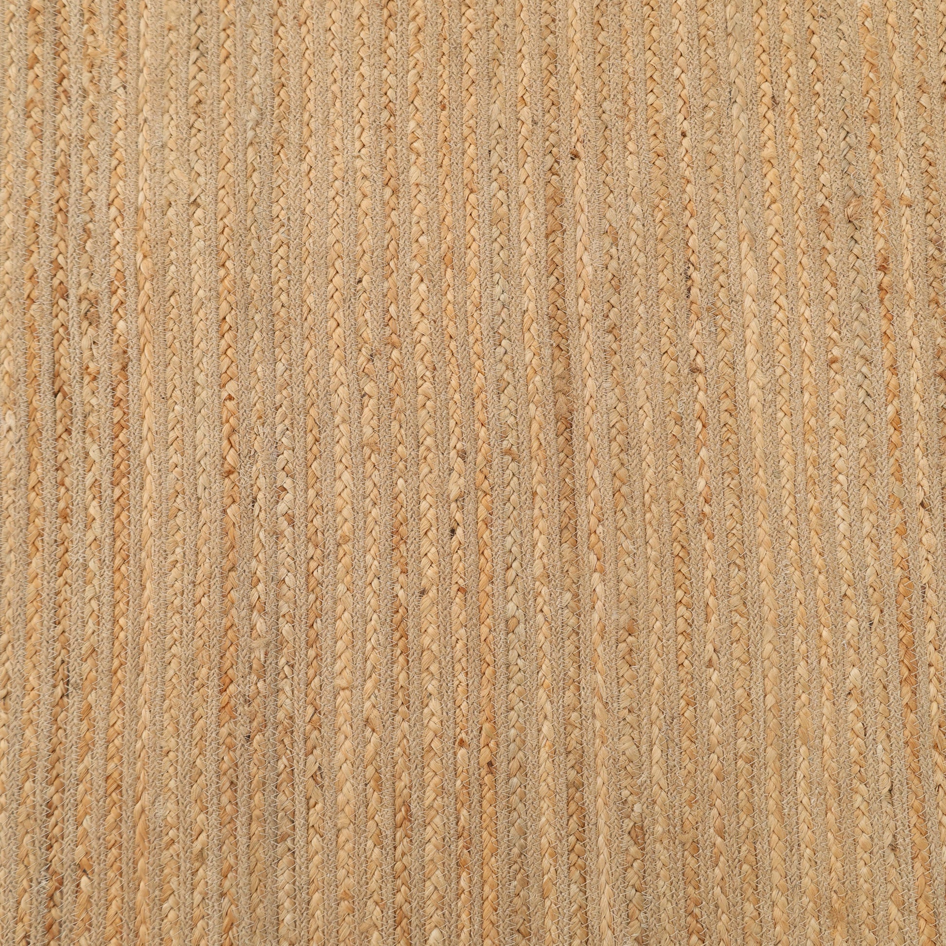 Close-up of the RAMSHA HOME Luxurious Handmade Jute Home Decor Floor Braided Rug (BR 087) featuring tightly woven beige and light brown strands for a beautifully textured natural fiber look.