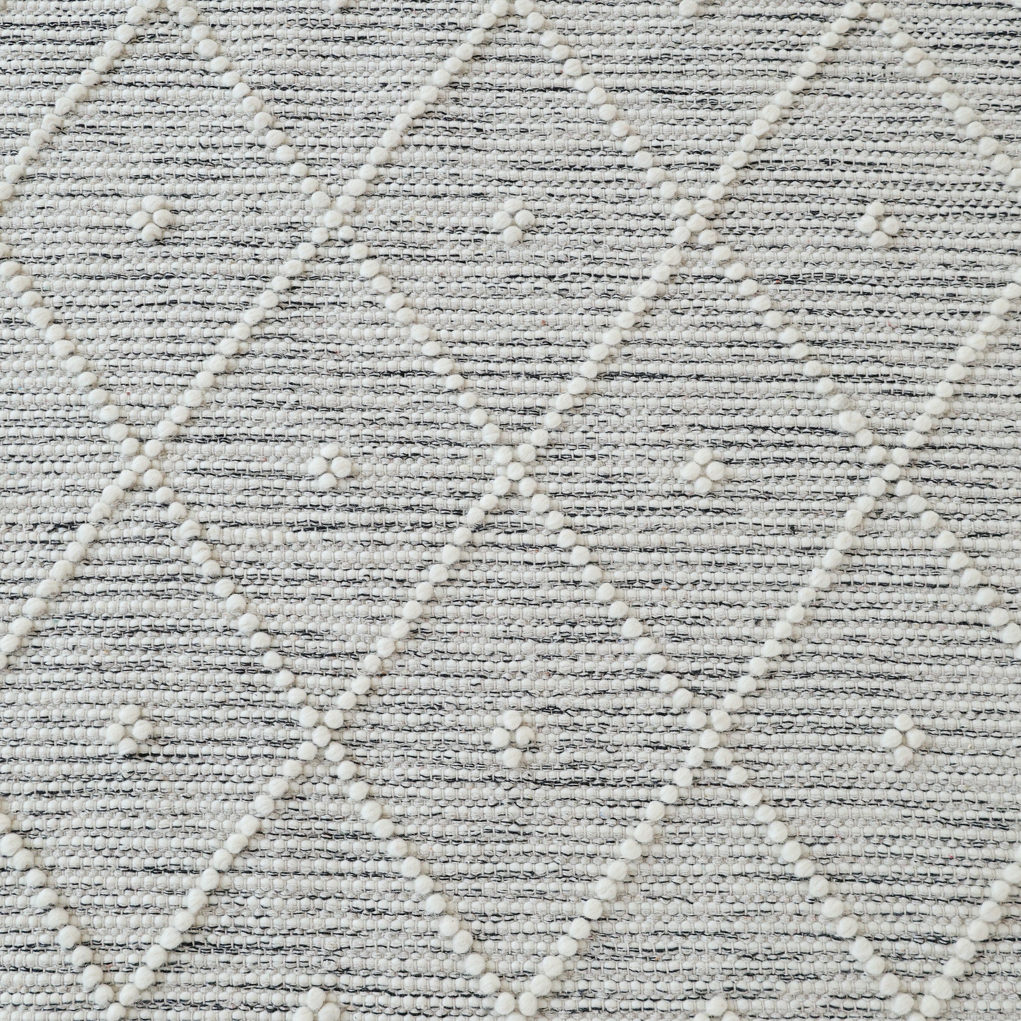 The RAMSHA HOME Natural & White Color Woven Rug SRN-012 features a textured diamond pattern with raised white dots, hand tufted from NZ wool for a soft, modern look in light and white grey tones.