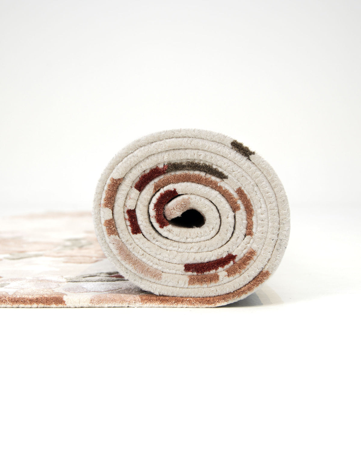 A rolled-up RAMSHA HOME Floral Blossom Area Rug in Beige, Pink, and Terracotta (300x400 CM – HTV-30), featuring a floral-inspired pattern, is positioned upright on a plain white background.