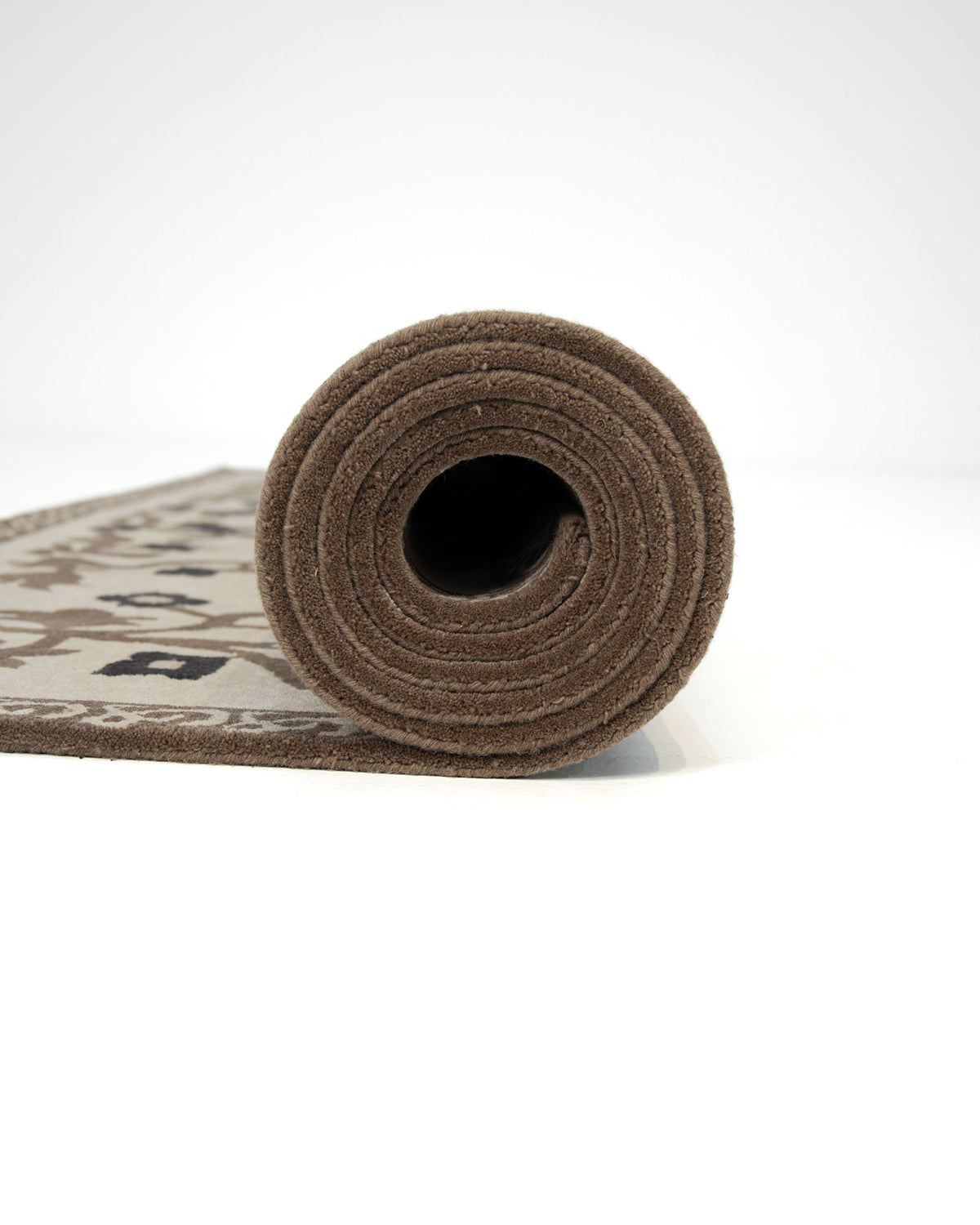 A rolled-up RAMSHA HOME Multi Color Handmade Carpet (300x400 CM, HTW-05) featuring a patterned design is shown standing upright on one end against a plain white background.