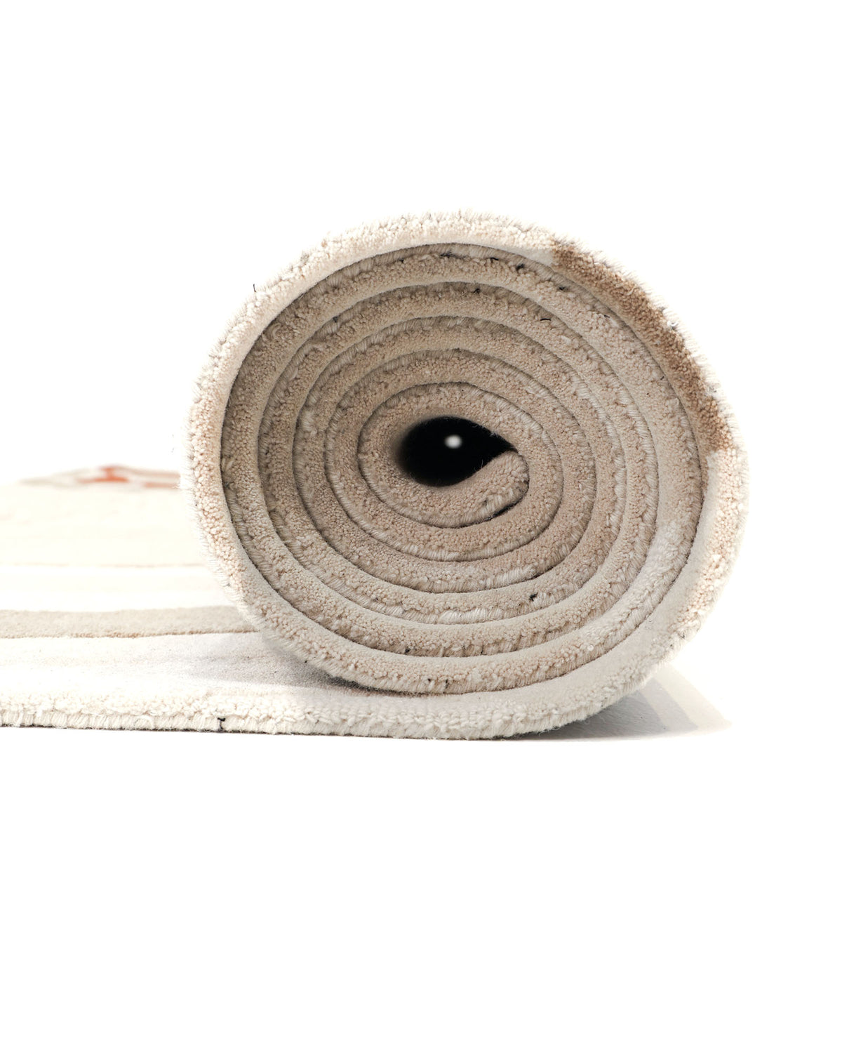 A close-up side view of the Modern Handmade Carpet 300x400 Multi – HTW-120 by RAMSHA HOME, rolled into a tight spiral against a white background. The hand-tufted wool fibers and the precise rolls are clearly visible.