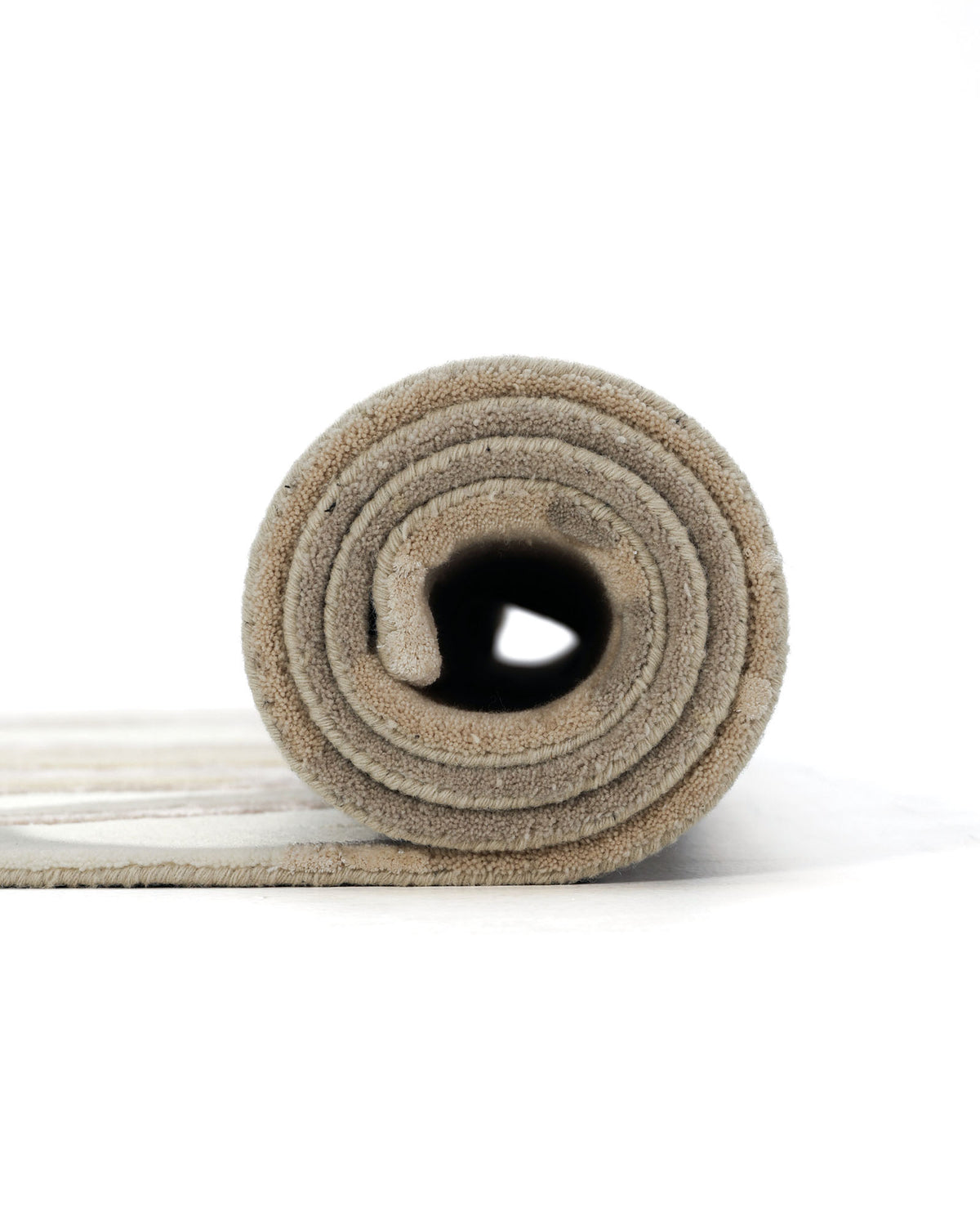 A close-up of the RAMSHA HOME Abstract Wool & Viscose Handmade Carpet 200x300 – HTWV-179, rolled up and displayed from the side against a white background.