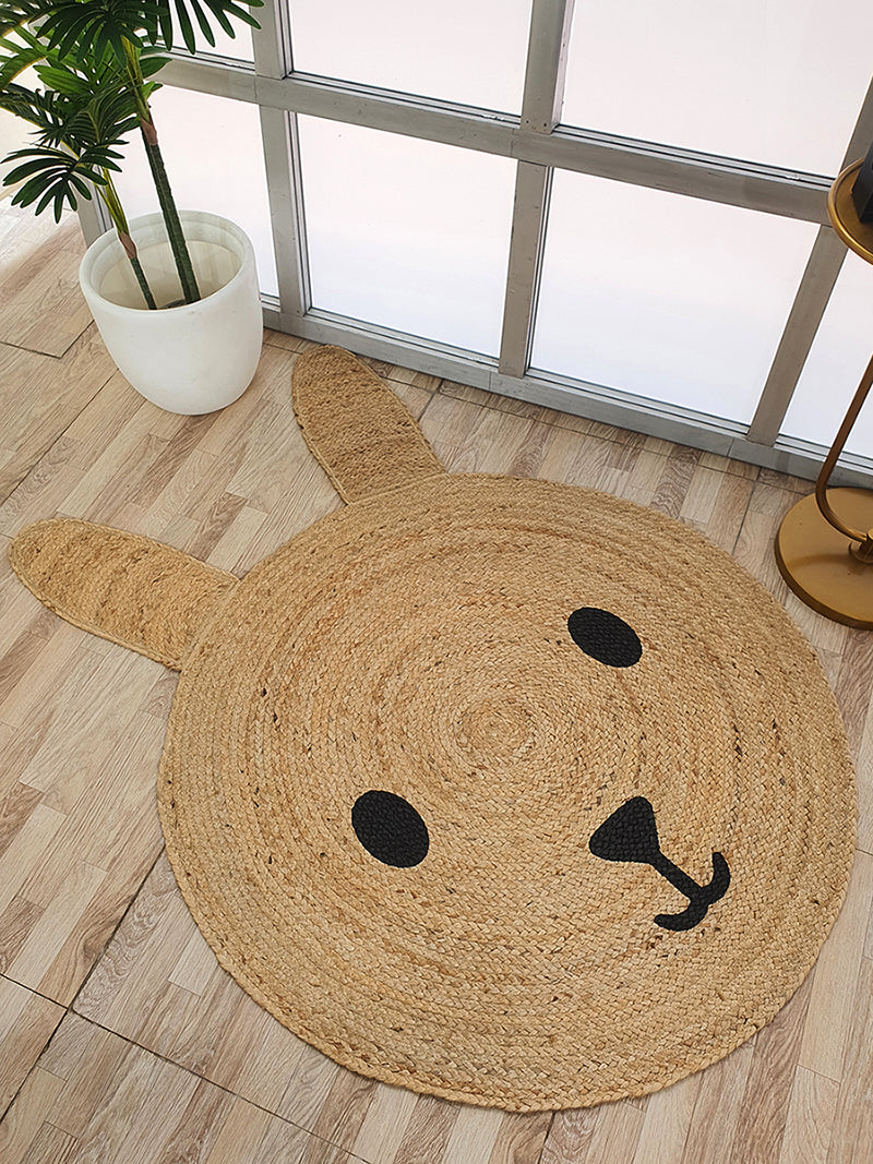 The Amazing Handmade Jute Round Braided Rug - BR 078 by RAMSHA HOME, featuring a playful rabbit design with cute ears, adds warmth and charm to any room’s decor.