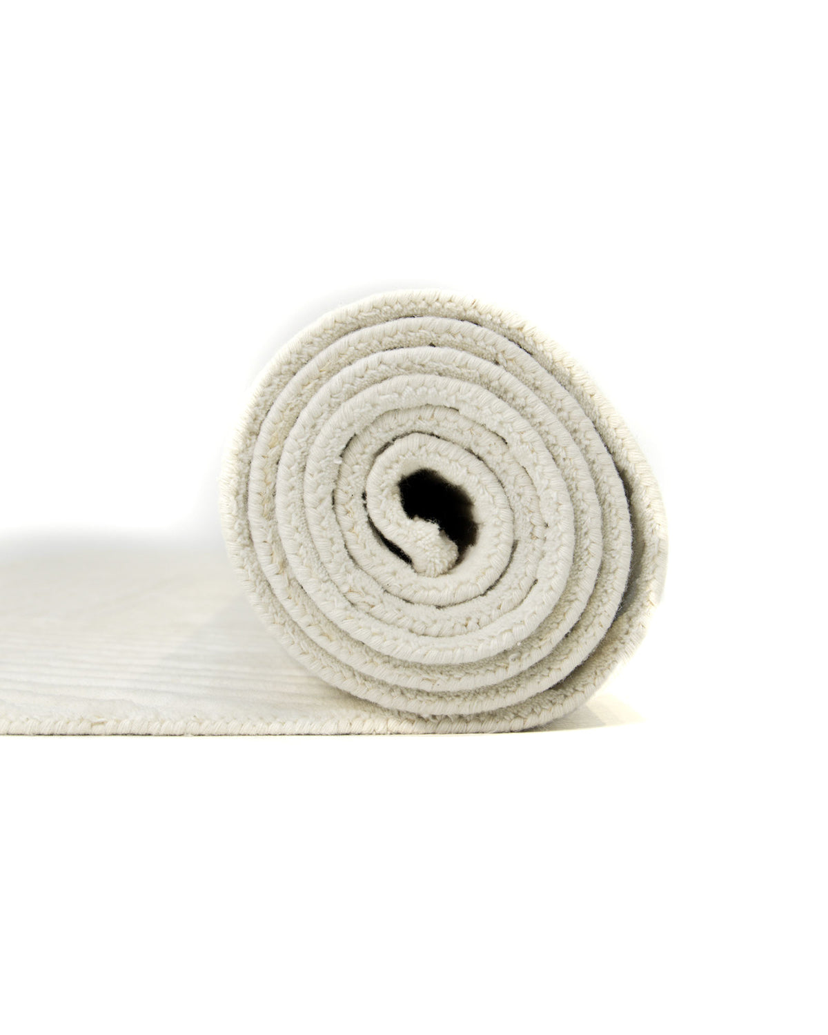 A rolled-up Geometric Woven Natural Color Handmade Area Rug (LKH-016) by RAMSHA HOME, featuring a soft, textured surface in light beige or ivory tones, is displayed against a white background.