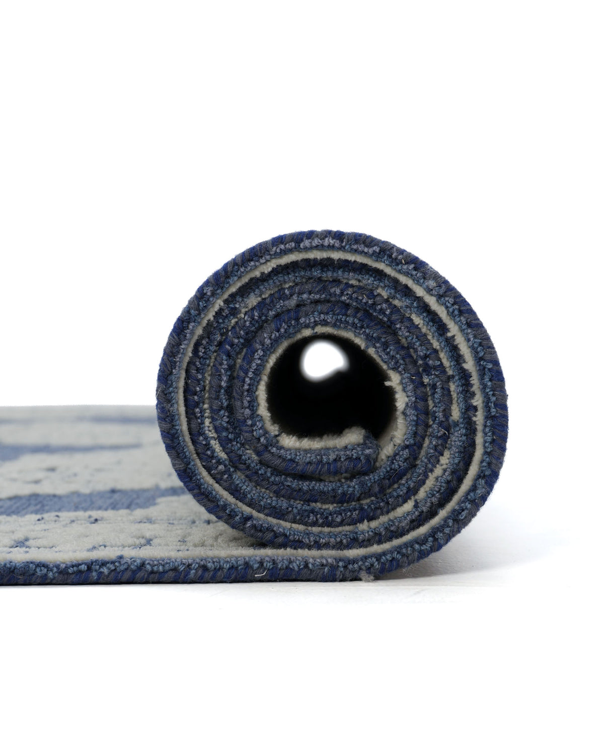 A side view of the RAMSHA HOME Blue Mosaic Handcrafted Luxury Area Rug-HTW 145, featuring blue and white stripes, is shown rolled up on a white background.
